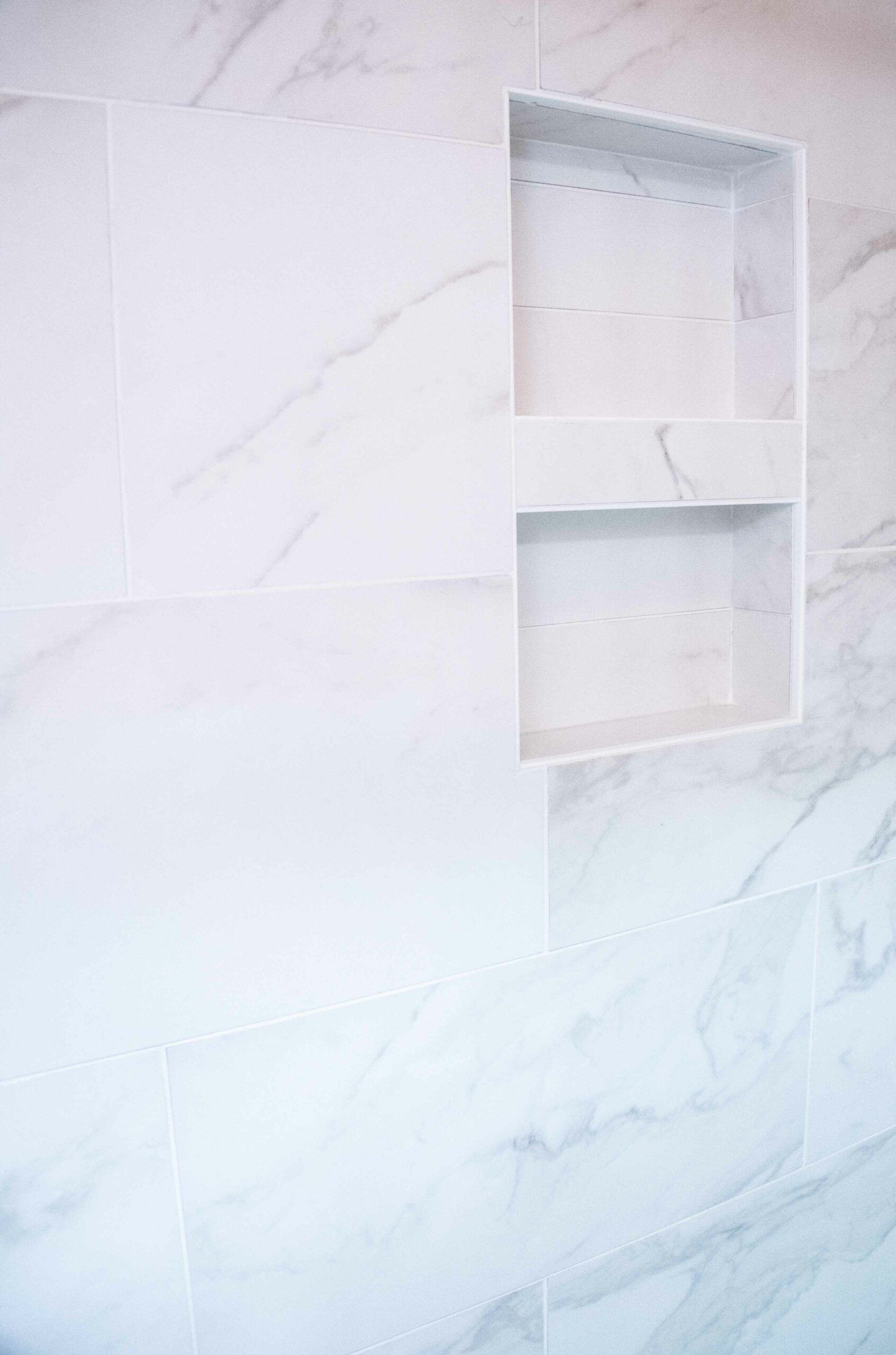 White textured wall with a recessed built-in shelf niche.