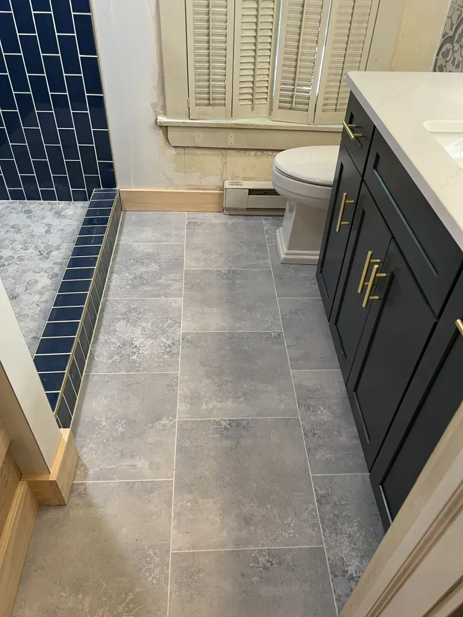 Modern bathroom showroom with glass shower stalls and chrome fixtures