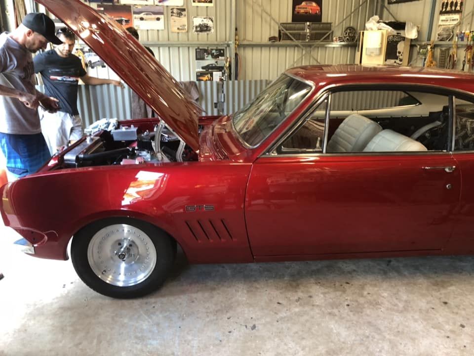 A Red Car With the Hood Up in a Garage — JJE Automotive In Yarrawonga, NT