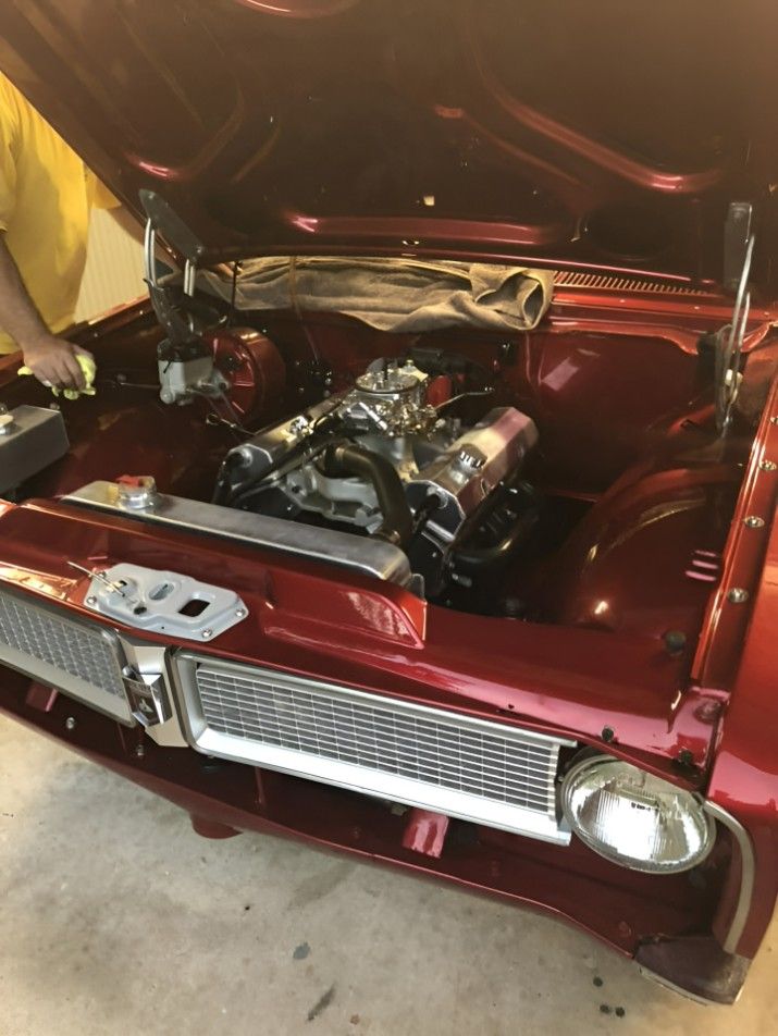 A Man is Working on a Red Car With the Hood Open — JJE Automotive In Yarrawonga, NT