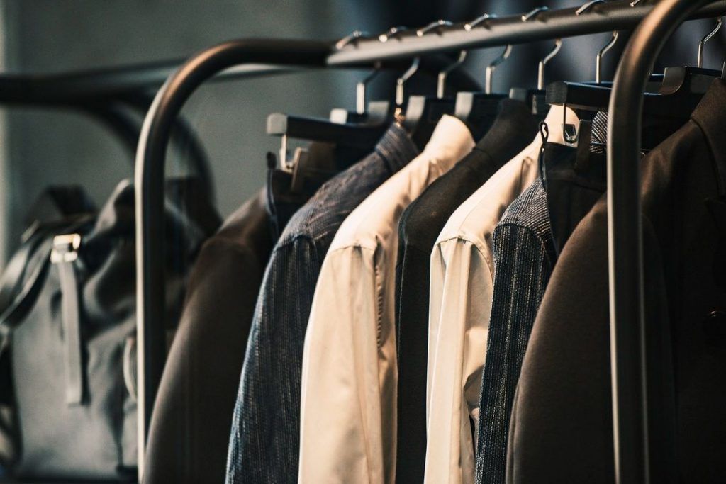 A row of jackets hanging on a rack in a store