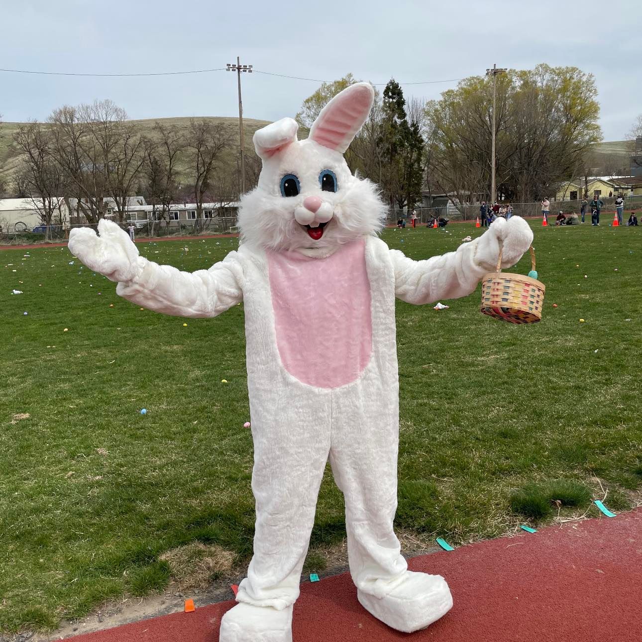 Easter Bunny with open arms holding a basket