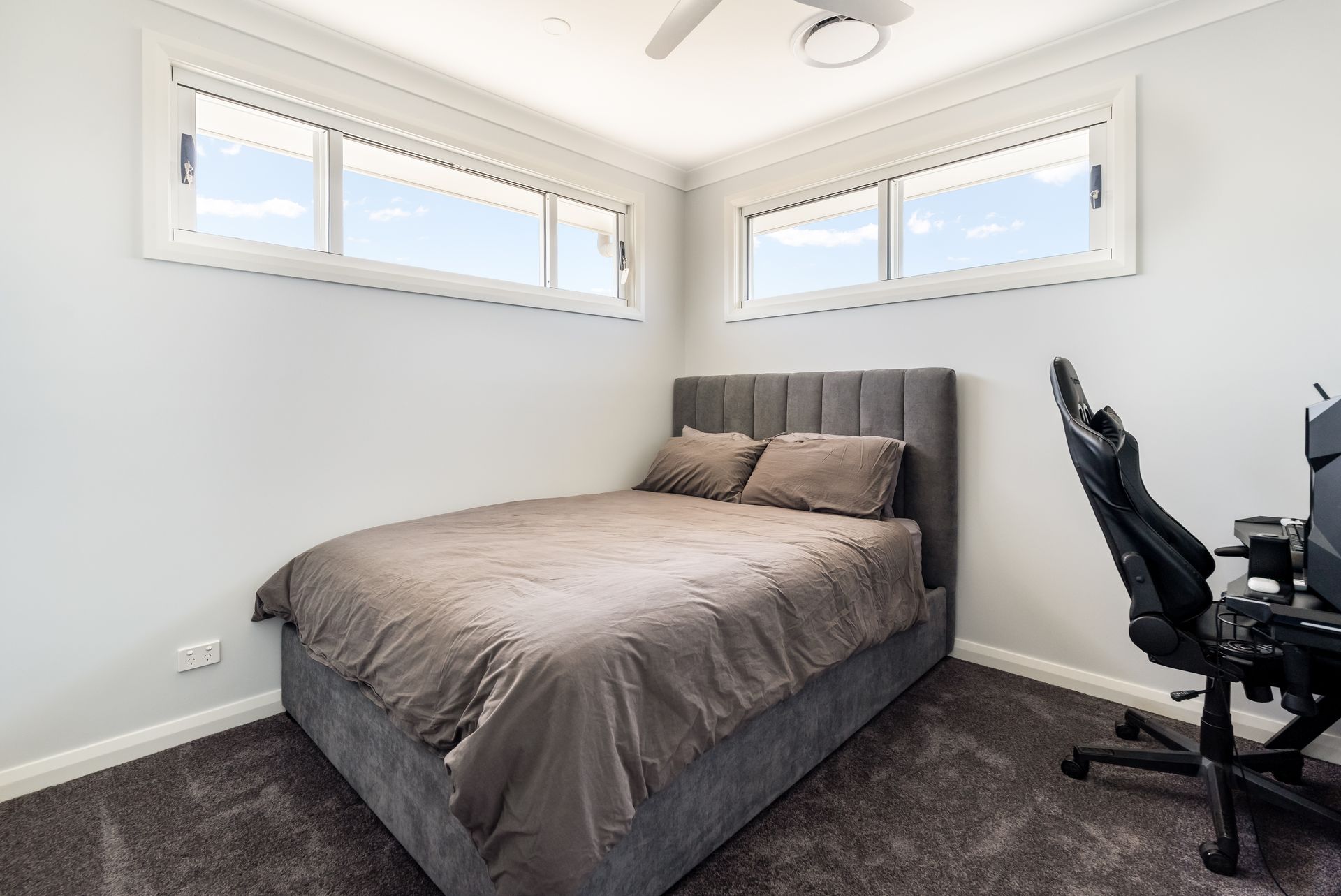 Small Bedroom With Bed, Two Windows, and a Black Office Chair by a Desk — Matt Made Building in Camden, NSW