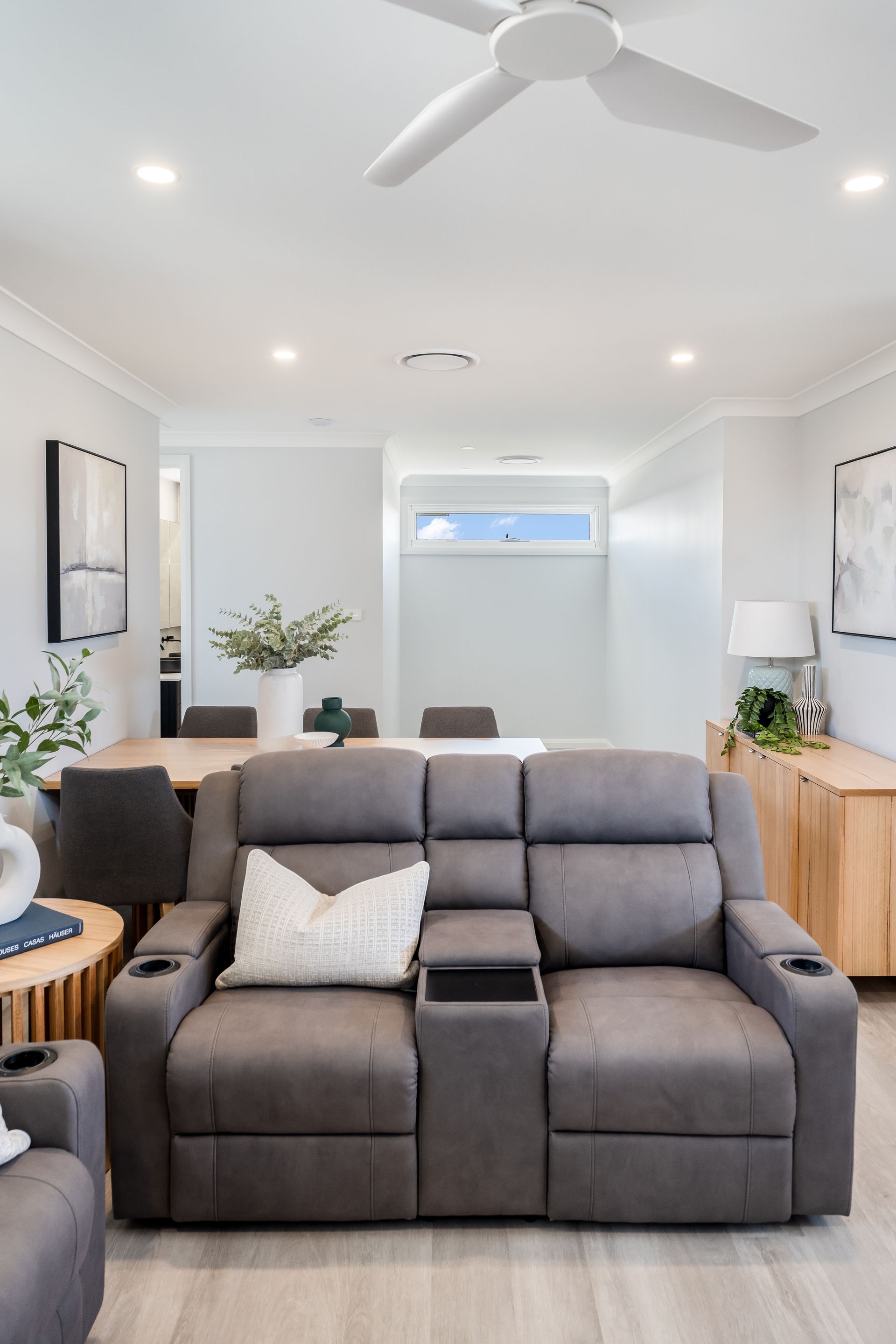 Modern Living Room With Gray Recliner Sofa and Light Wood Sideboards — Matt Made Building in Camden, NSW
