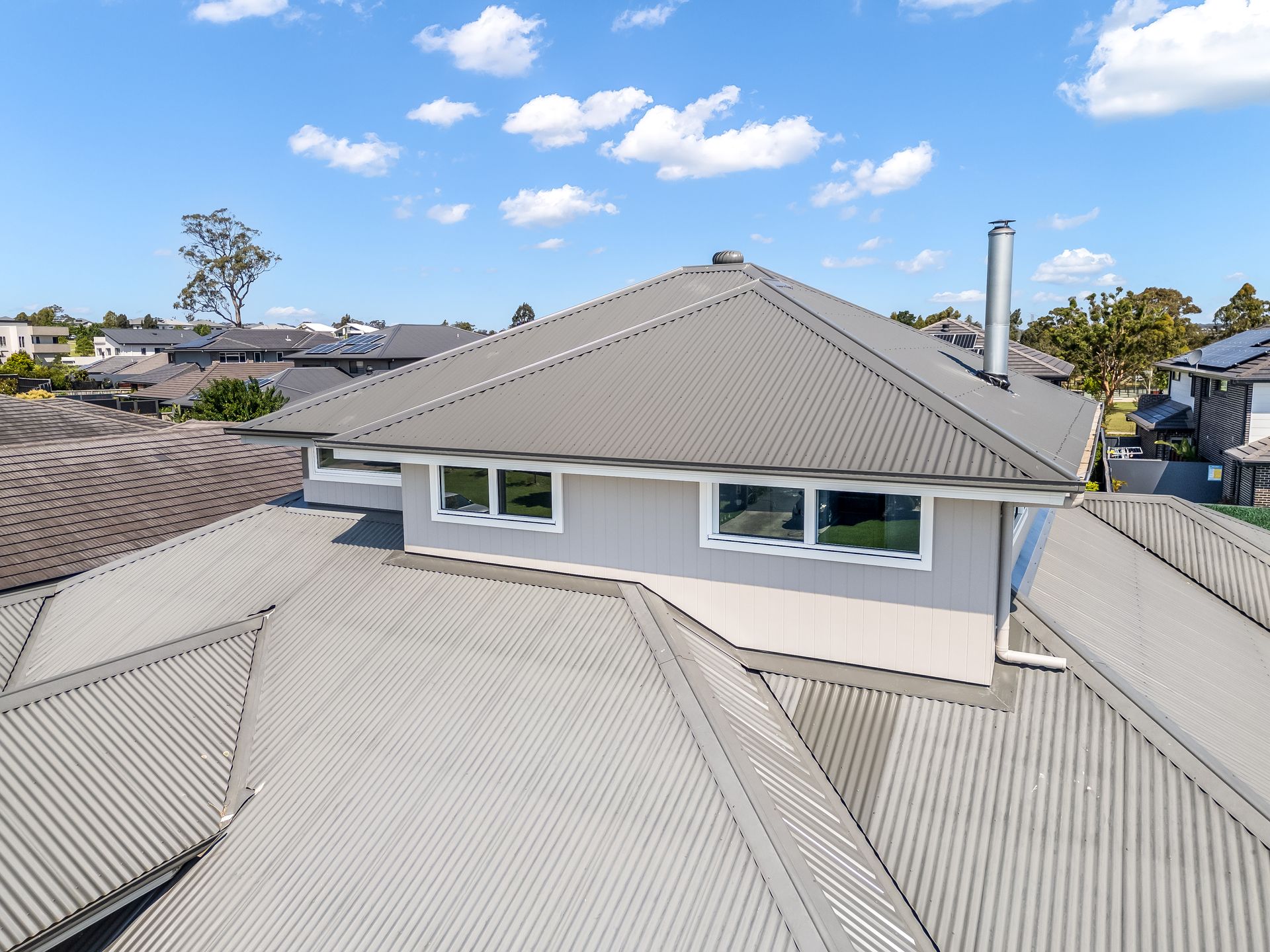 Aerial View of Gray-roofed Houses Under a Blue Sky — Matt Made Building in Camden, NSW