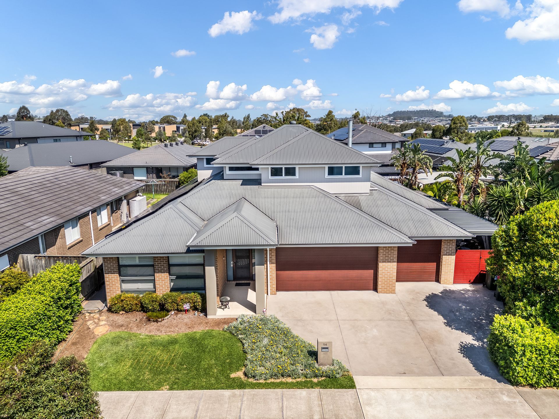 Suburban House With Gray Roof, Red Garage Doors — Matt Made Building in Camden, NSW
