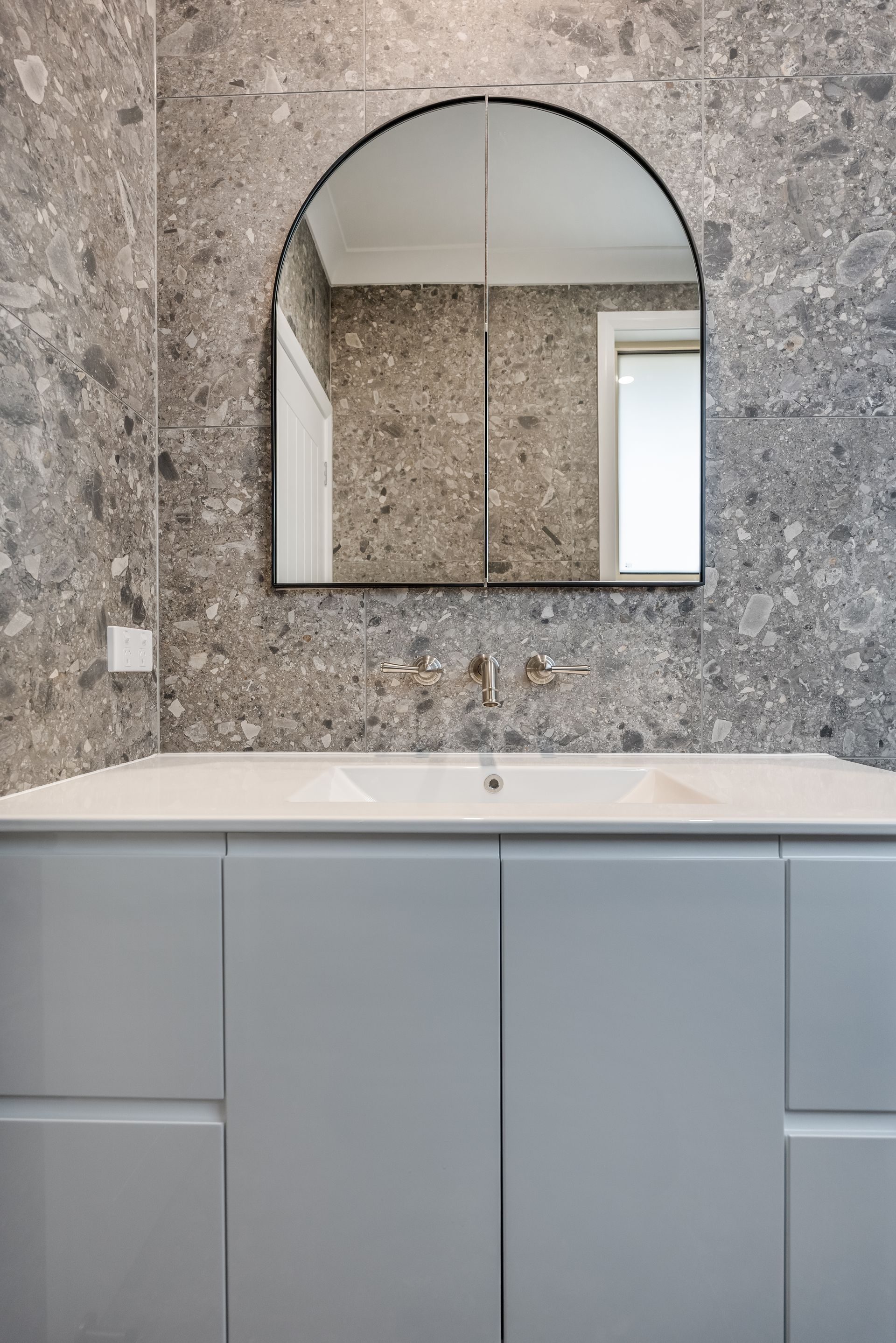 Modern Bathroom Vanity With Gray Cabinet and Arched Mirror — Matt Made Building in Camden, NSW