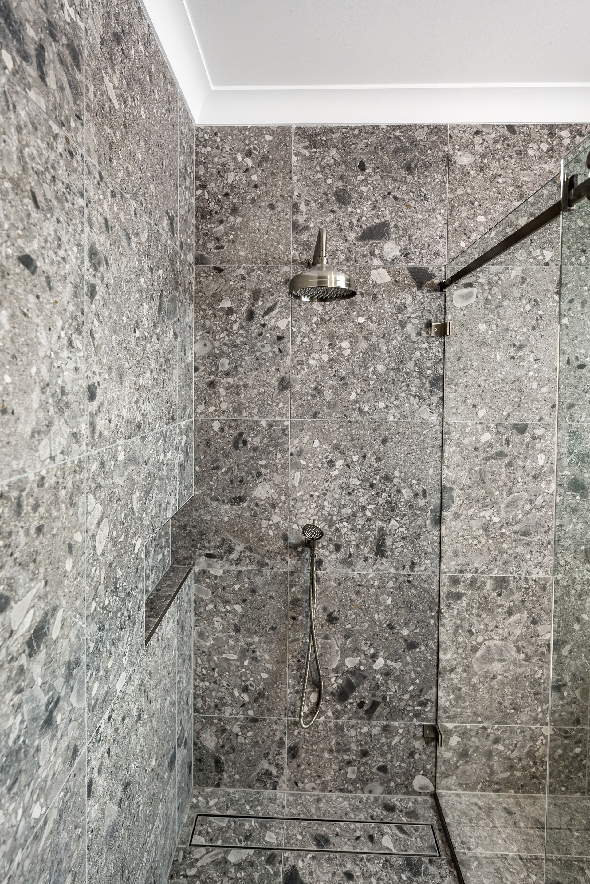Gray Tiled Shower Wall With a Mounted Showerhead and Hose — Matt Made Building in Camden, NSW