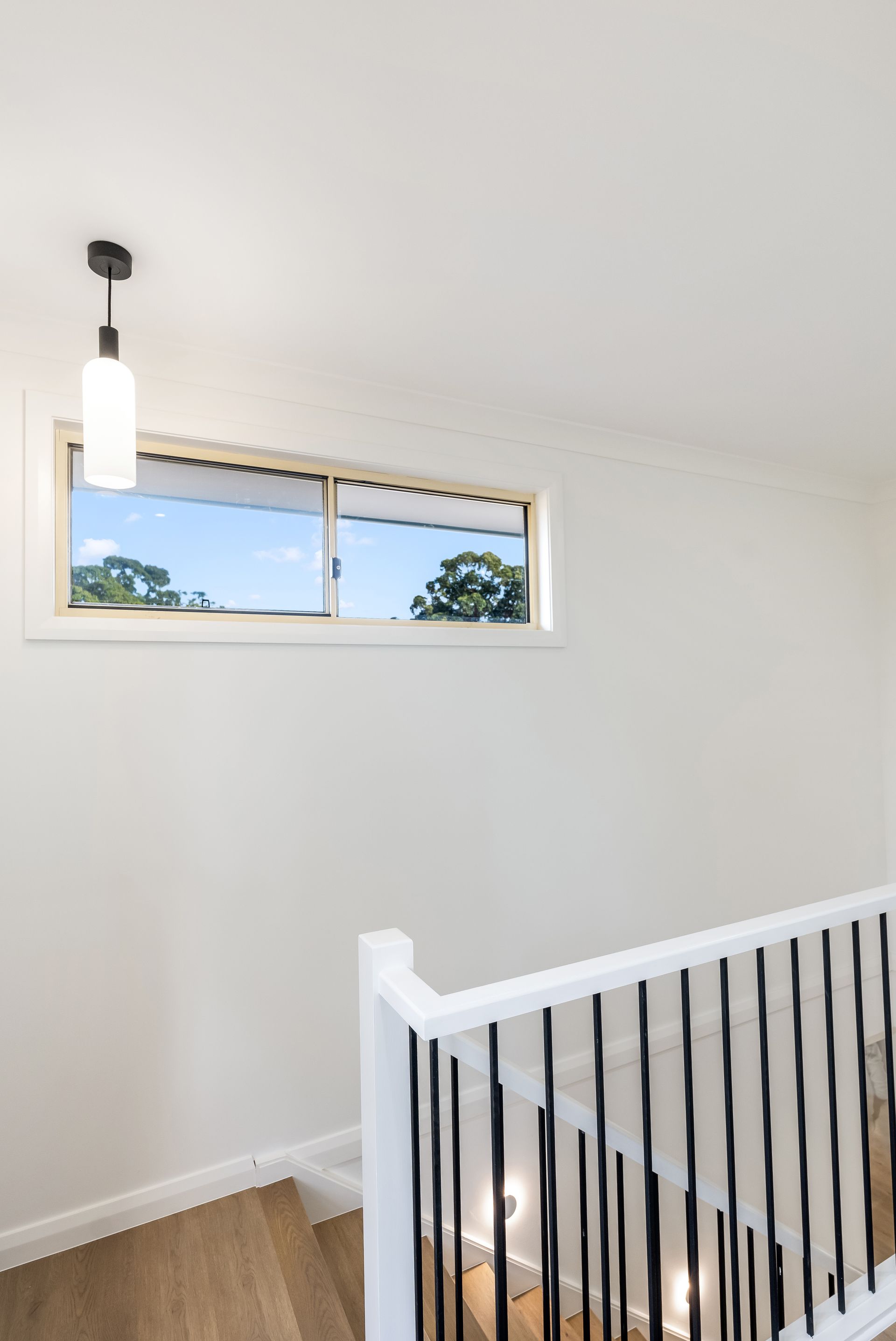 Bright Stair Landing With White Walls Black-and-white Railing — Matt Made Building in Camden, NSW