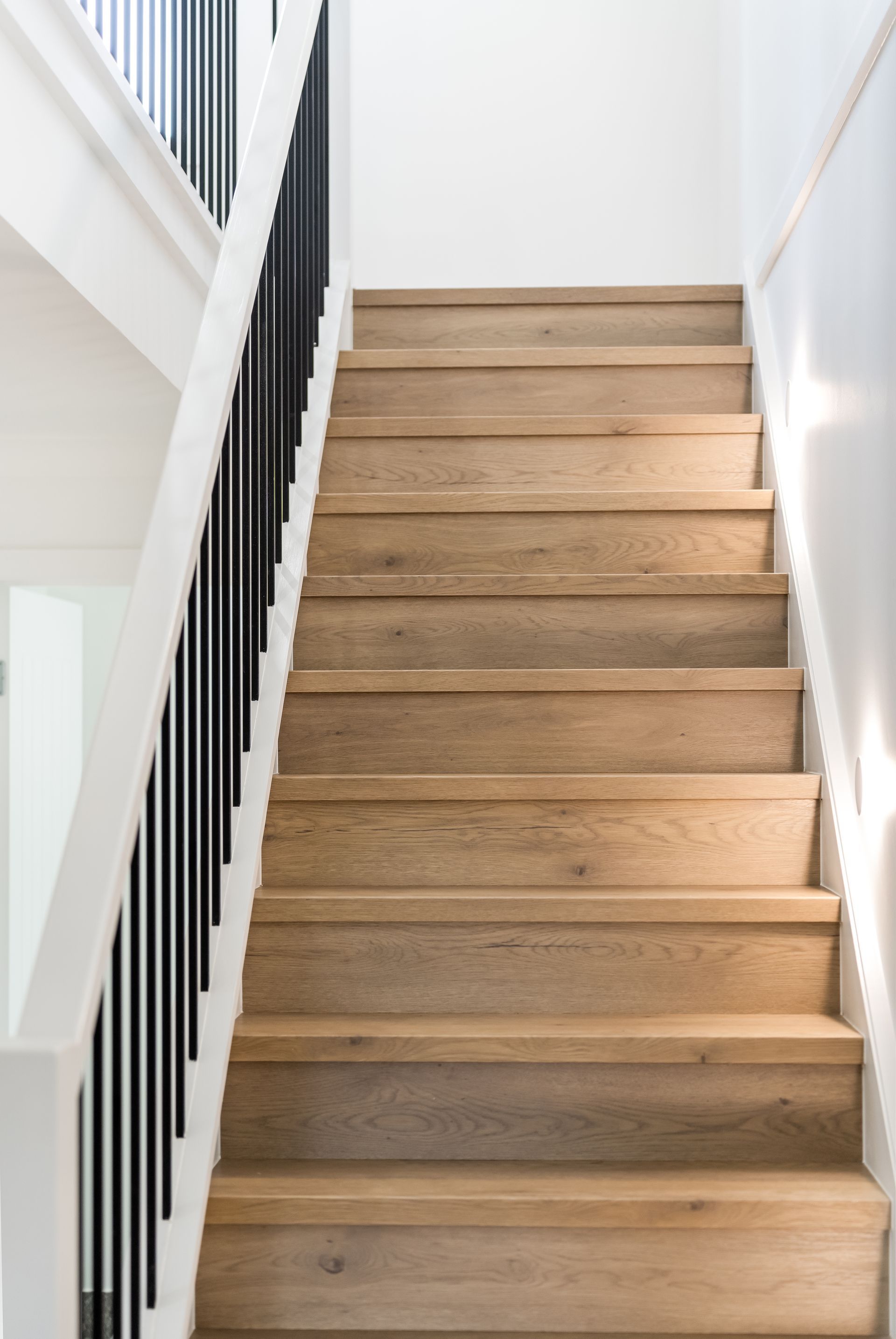 Narrow Wooden Staircase With White Walls and Black Handrail — Matt Made Building in Camden, NSW