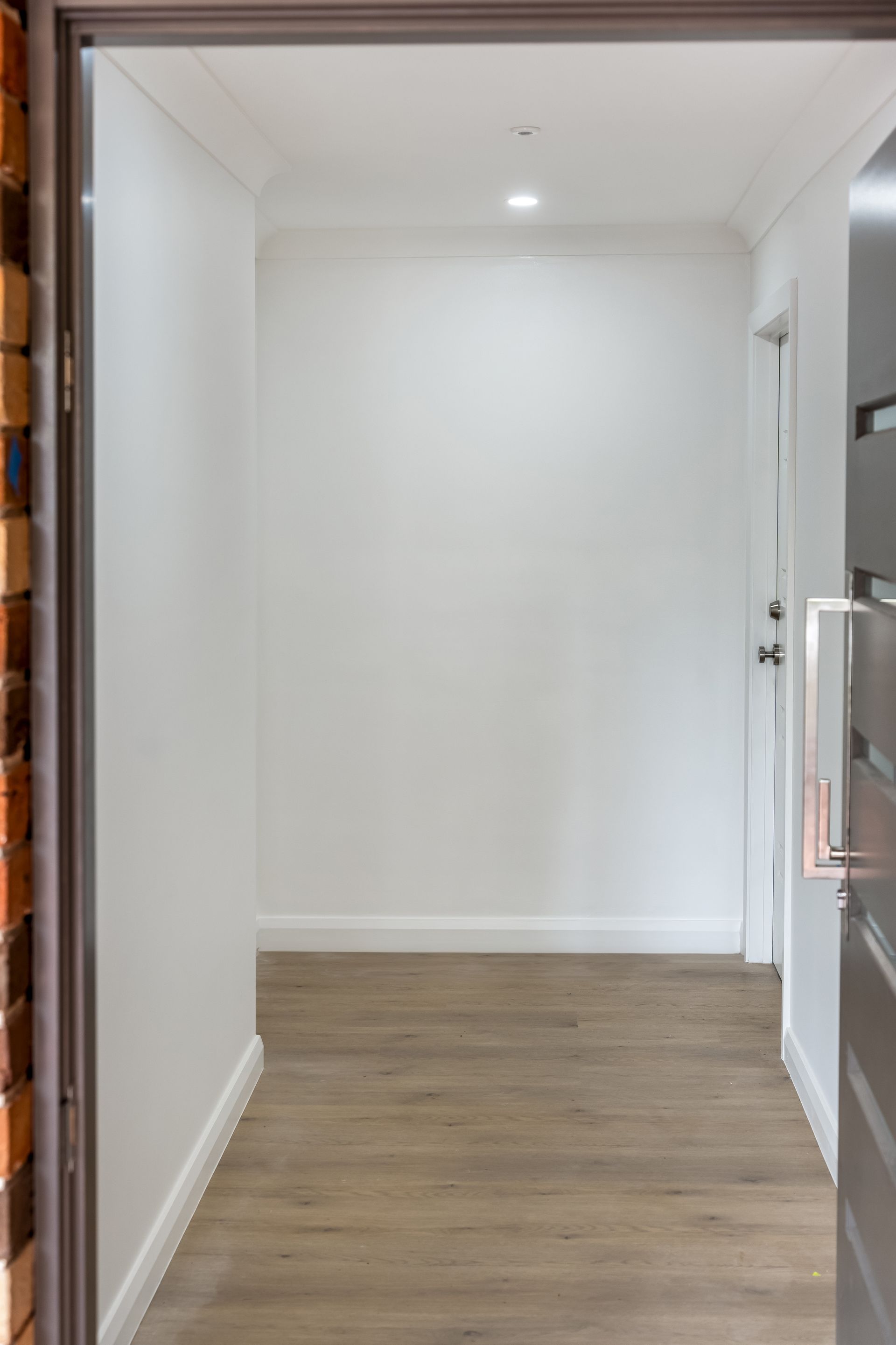 Empty Hallway With White Walls, Wood Floor and a Door on the Right — Matt Made Building in Camden, NSW
