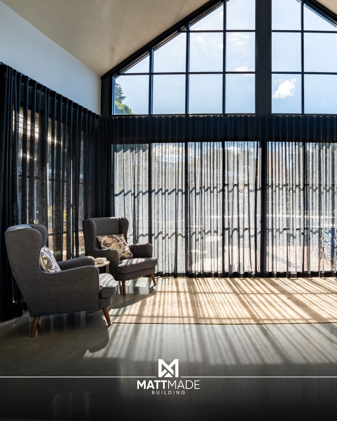 Sunlit living room with tall windows — Matt Made Building in Campbelltown, NSW