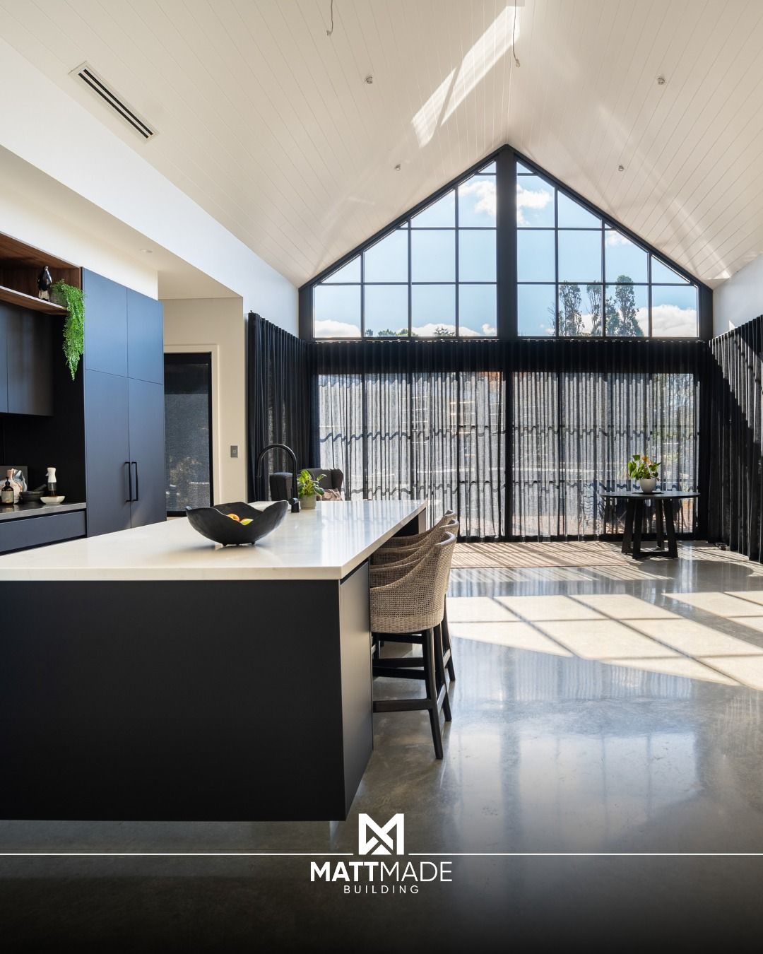 Modern black-and-white kitchen with a high vaulted ceiling — Matt Made Building in Campbelltown, NSW