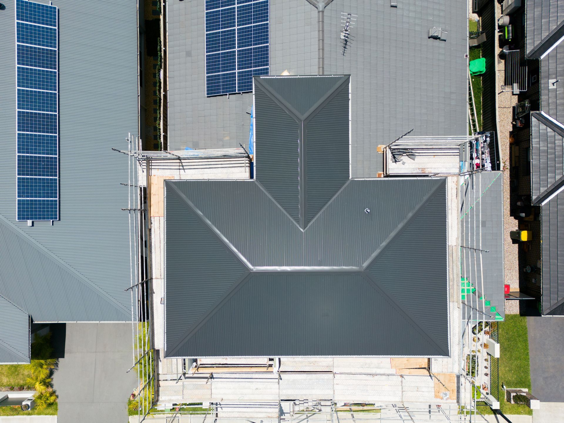 Aerial View of a House With a Dark Gray Roof and Blue Solar Panels — Matt Made Building in Camden, NSW
