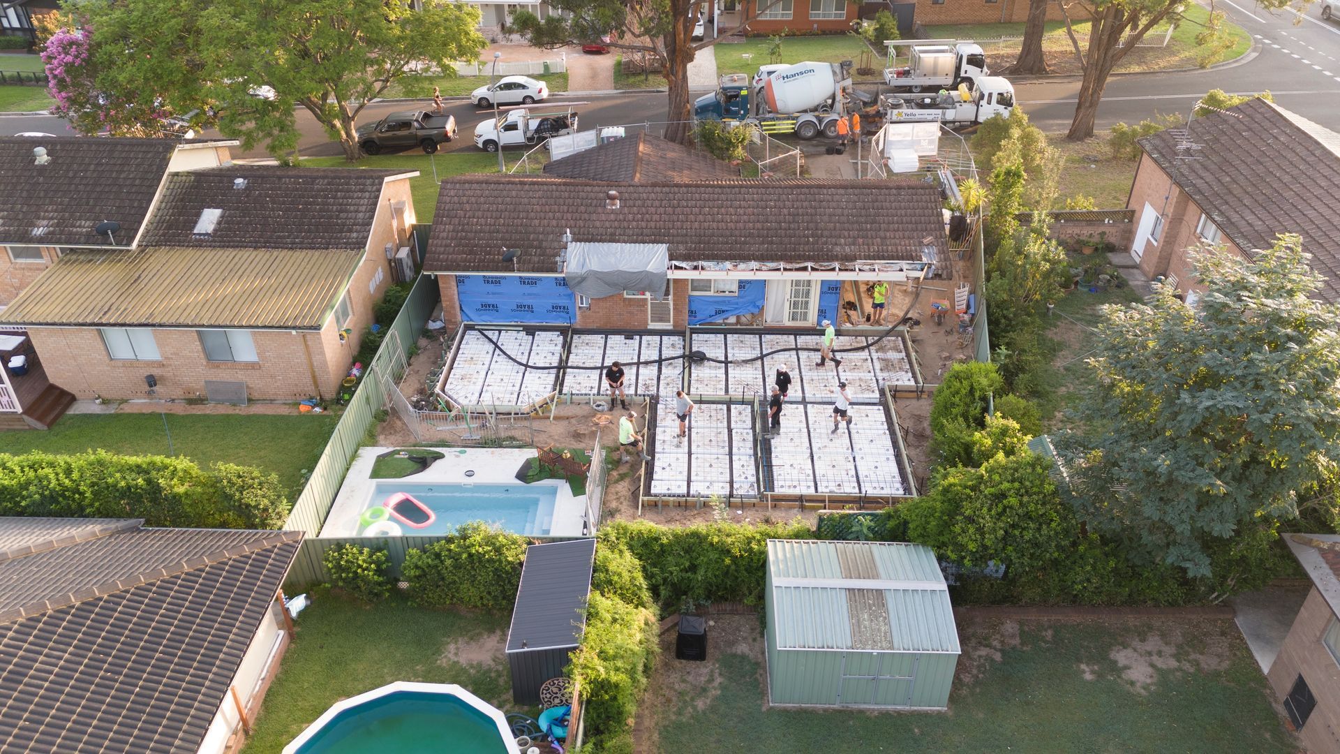 Aerial View of Suburban Houses With Backyards, Trees, Cars — Matt Made Building in Camden, NSW