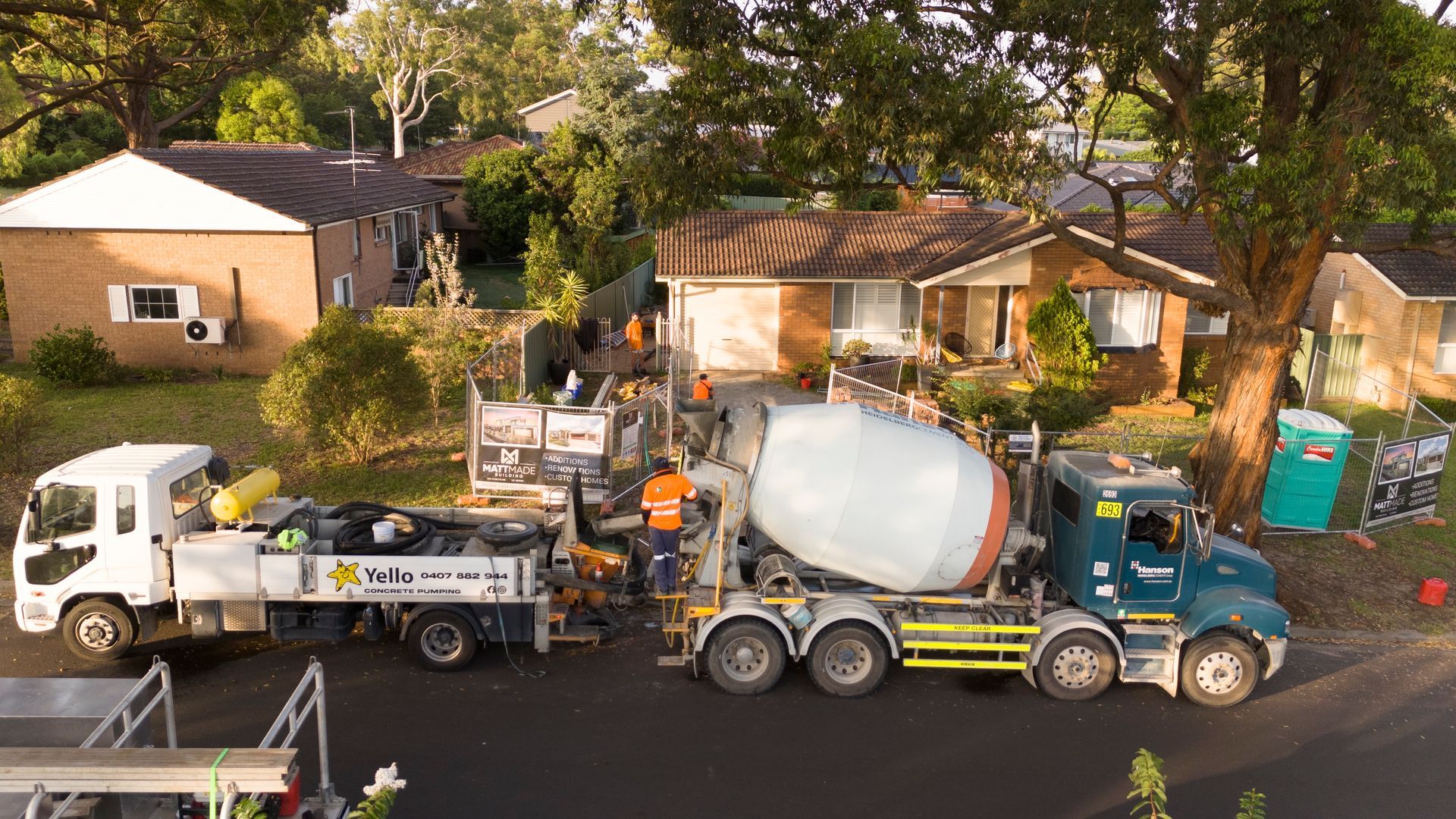 Concrete Mixer Truck and Work Crew on a Residential Street Near Houses — Matt Made Building in Camden, NSW
