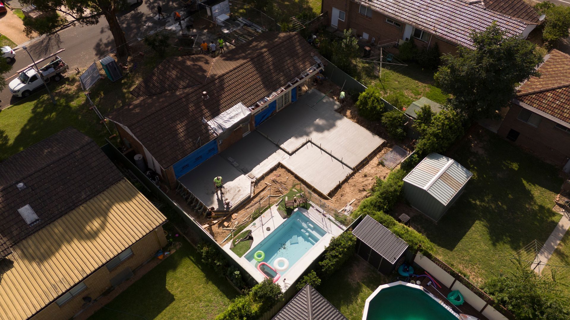 Aerial View of a Backyard With a Small Pool, Patio, Lawn, and Surrounding Houses — Matt Made Building in Camden, NSW