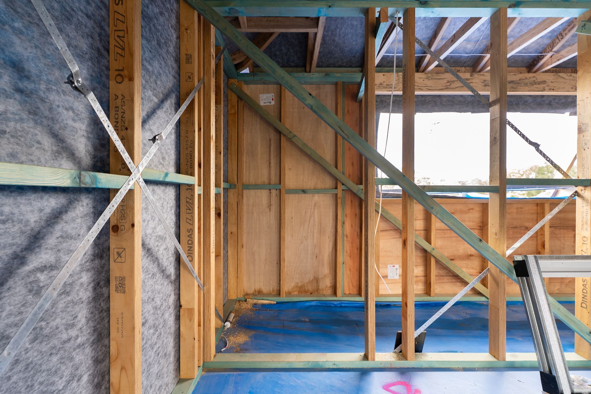 Wood-framed House Interior Under Construction With Blue Floor Sheeting — Matt Made Building in Camden, NSW