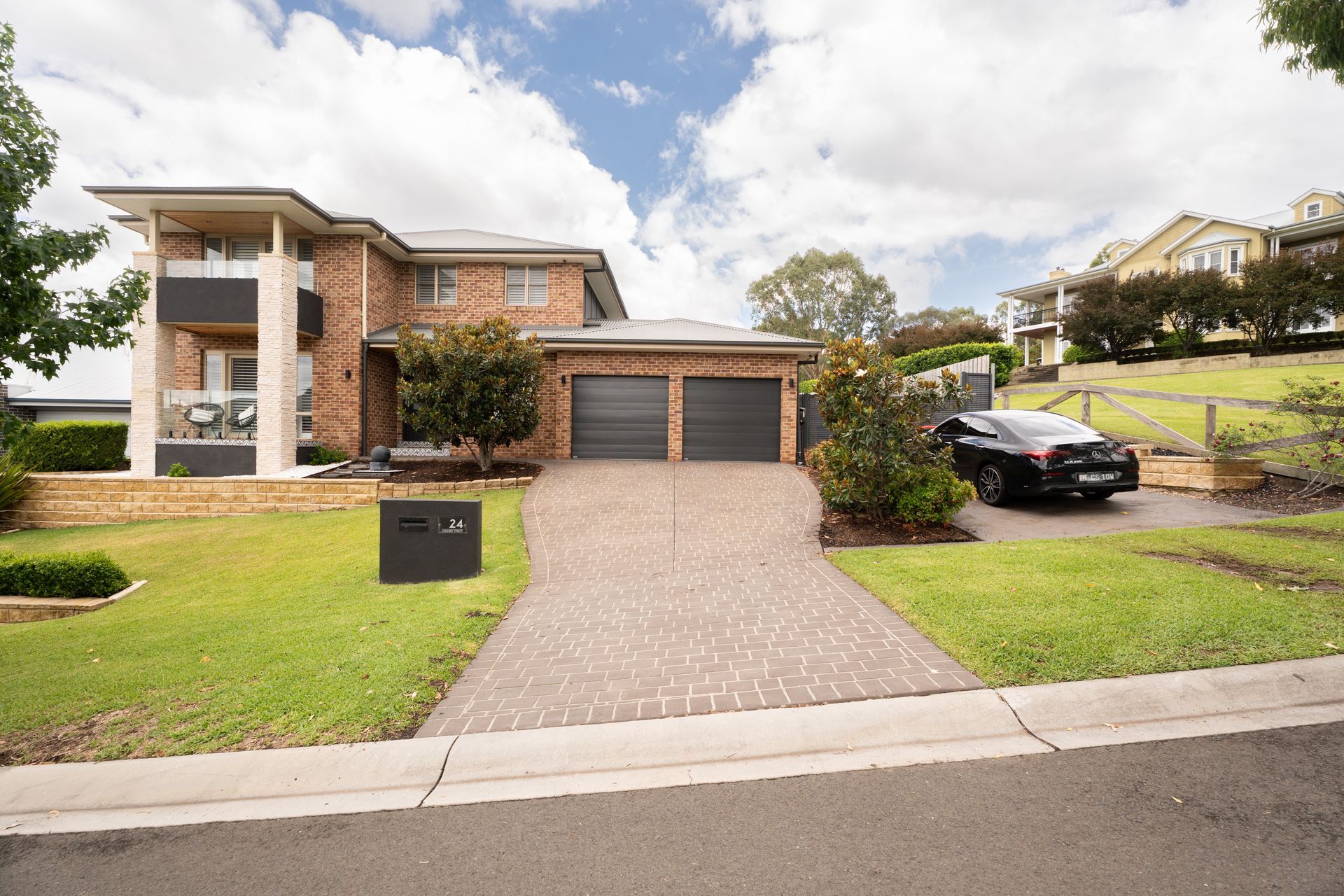 Two-story Beige House With a Garage, Deck, and Sloped Yard — Matt Made Building in Camden, NSW