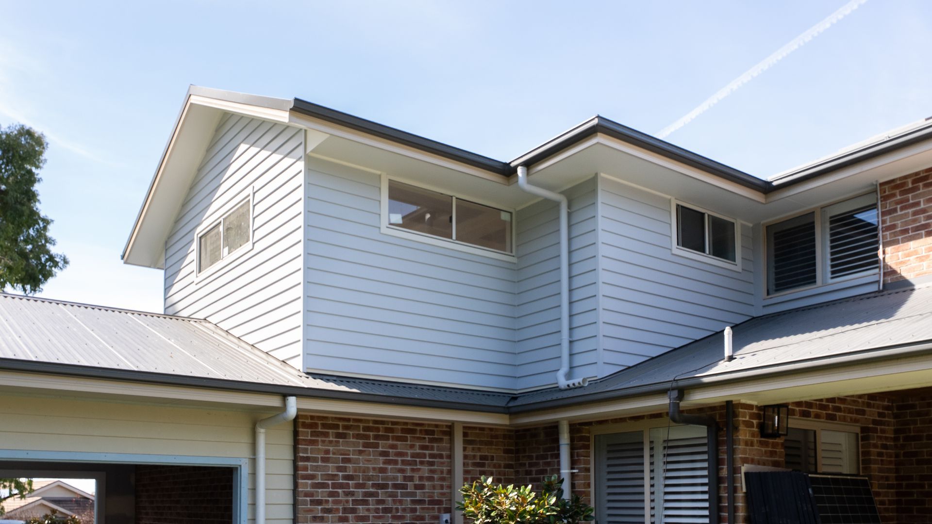 Backyard Patio Beside Brick and Siding Walls and Garden Tools Visible Inside — Matt Made Building in Camden, NSW