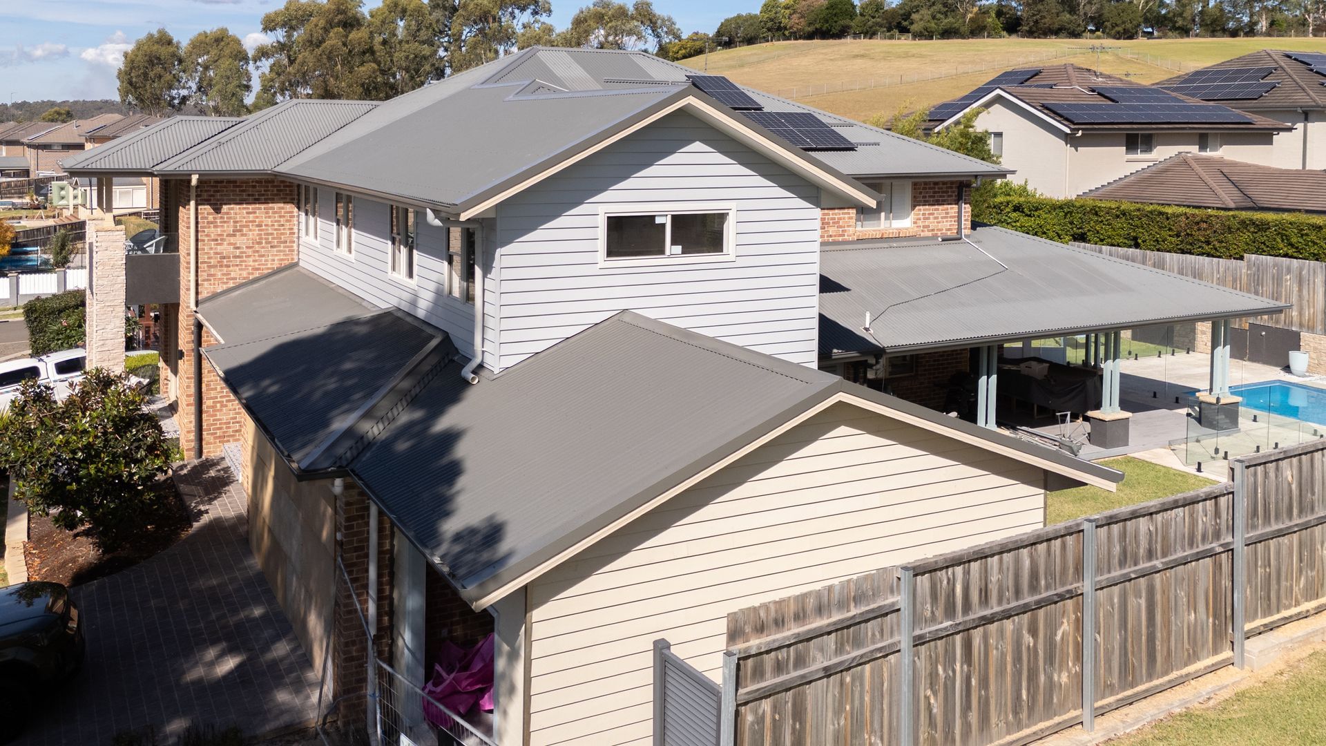 Suburban Backyard With Two-story House and Wooden Fence — Matt Made Building in Camden, NSW
