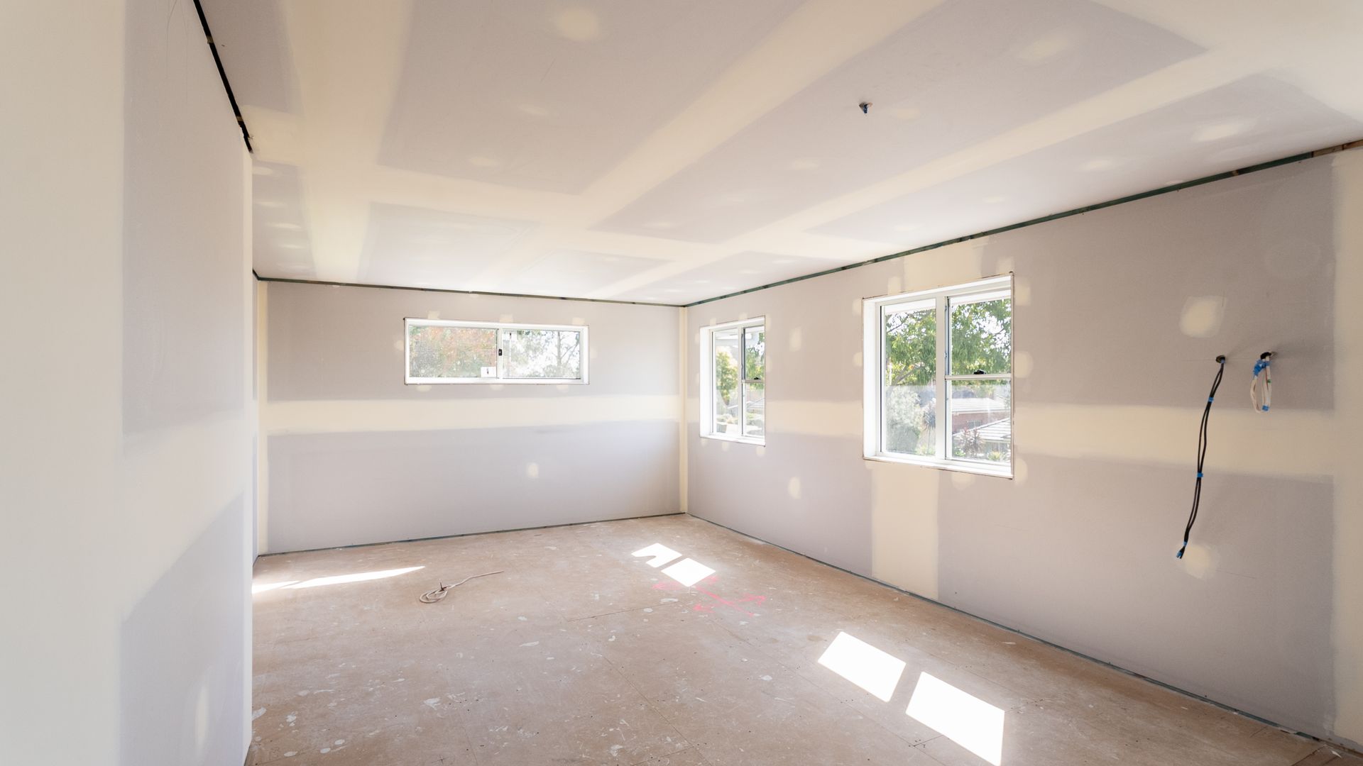 Empty Bright Room With White Walls and Three Windows Letting in Sunlight — Matt Made Building in Camden, NSW