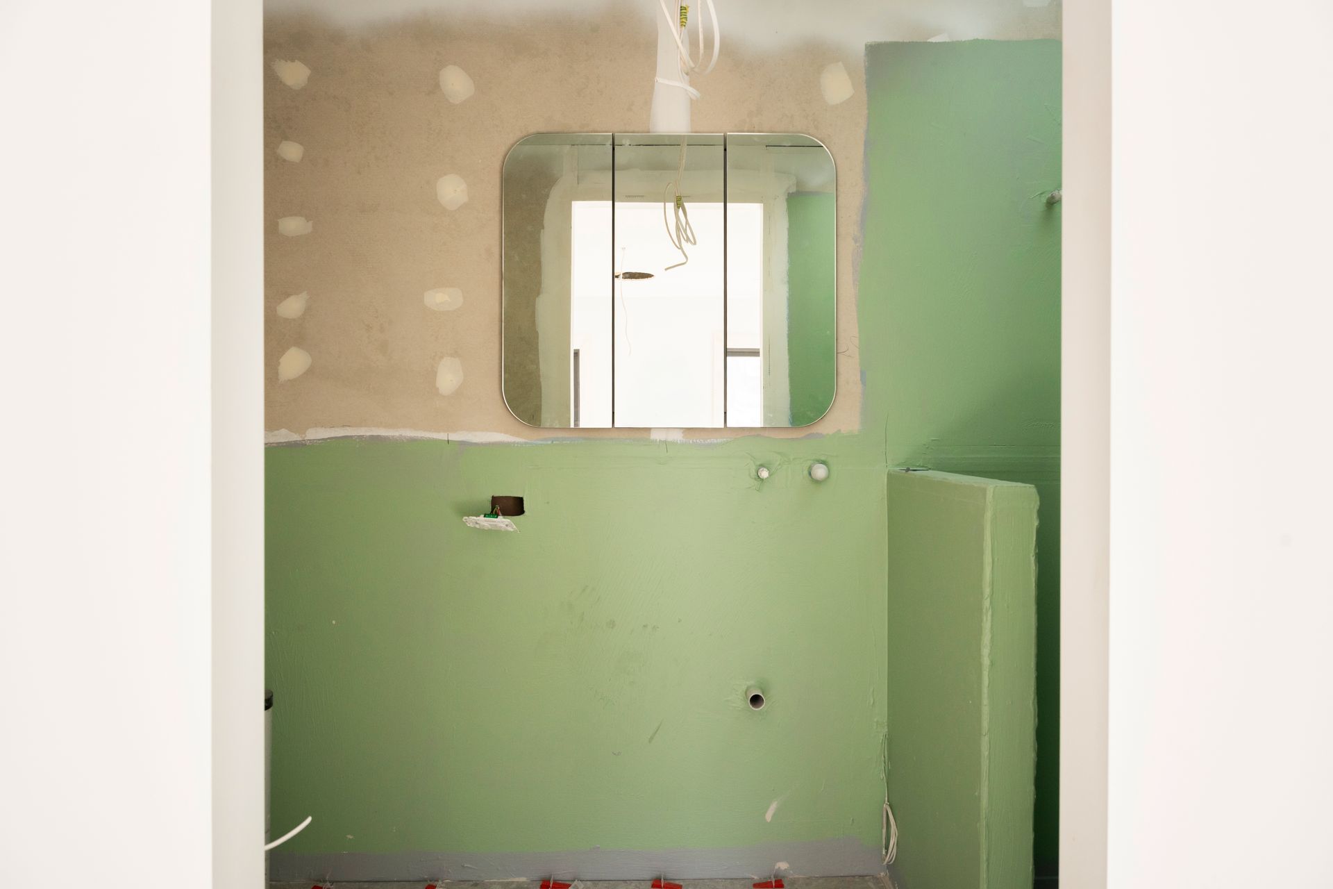Partially Renovated Bathroom With Green Walls, Unfinished Plaster — Matt Made Building in Camden, NSW
