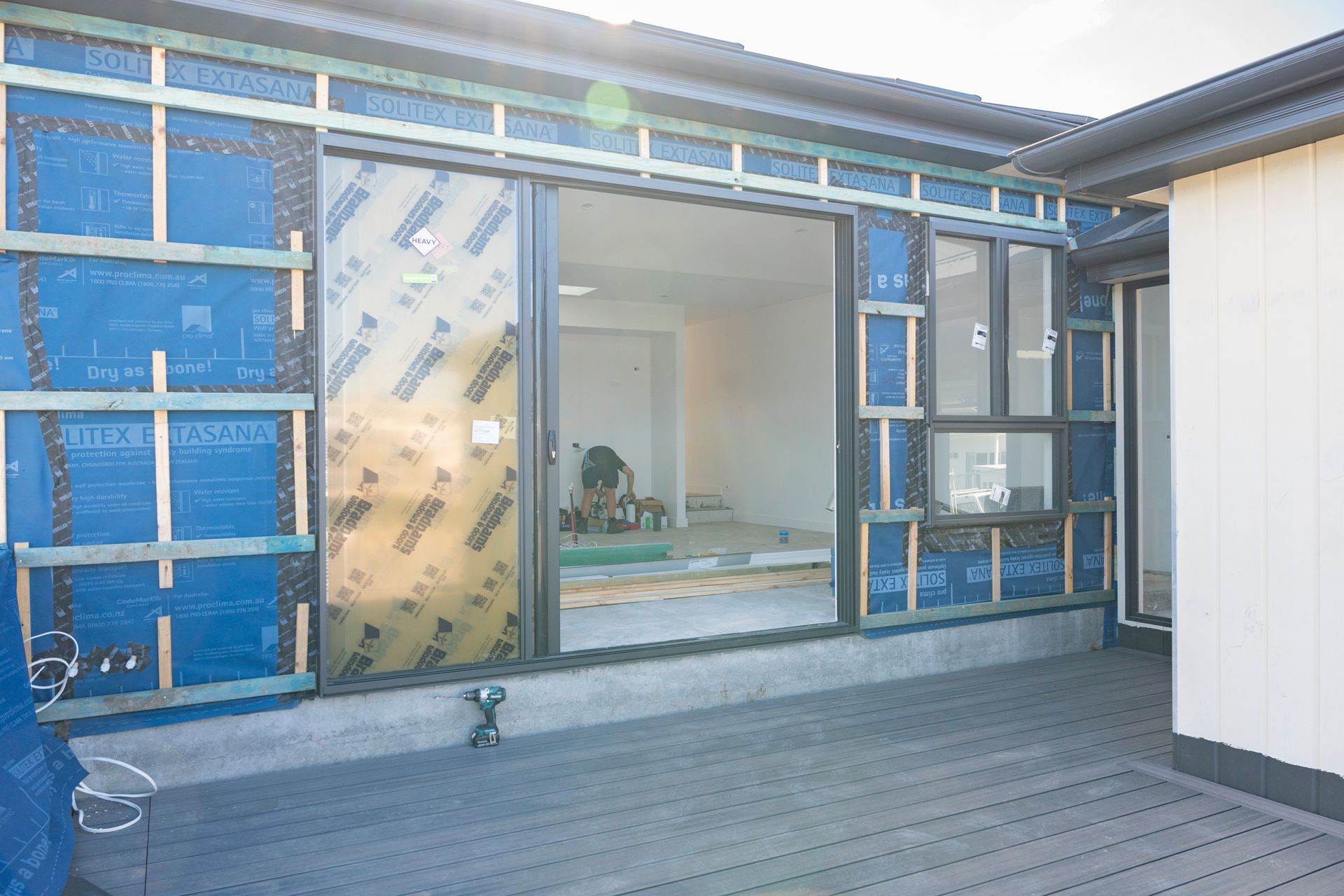 Modern House Exterior With Blue-trimmed Sliding Glass Doors — Matt Made Building in Camden, NSW
