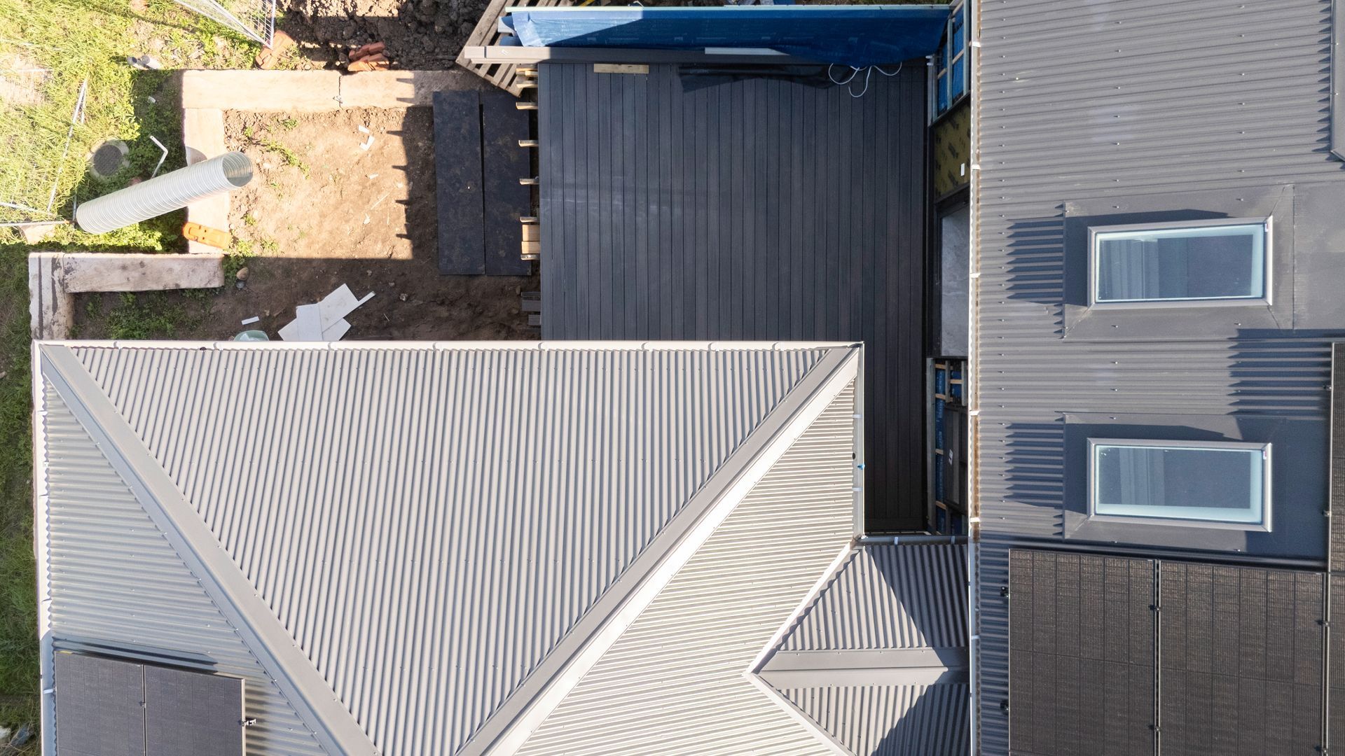 Aerial View of Gray Rooftops and a Blue-roofed Structure Beside a Small Yard — Matt Made Building in Camden, NSW