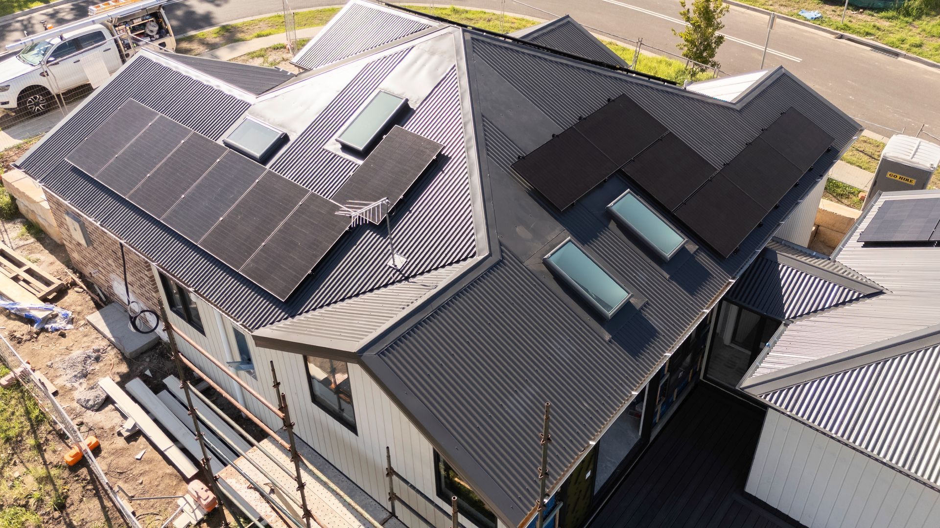Aerial View of a Dark-roofed House With Multiple Solar Panels — Matt Made Building in Camden, NSW