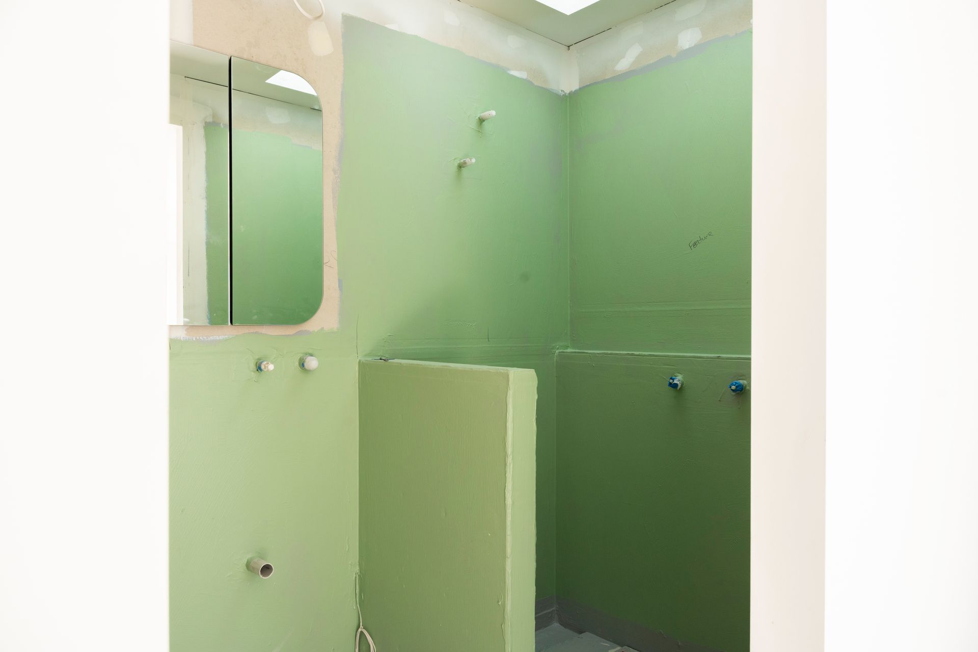 Green-painted Bathroom Stalls and Walls in a Tiled Restroom — Matt Made Building in Camden, NSW
