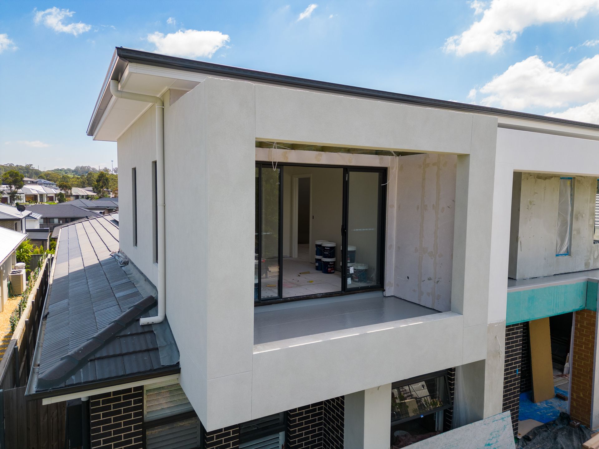 Modern White House Exterior With Large Balcony Window and Rooftop Terrace — Matt Made Building in Camden, NSW