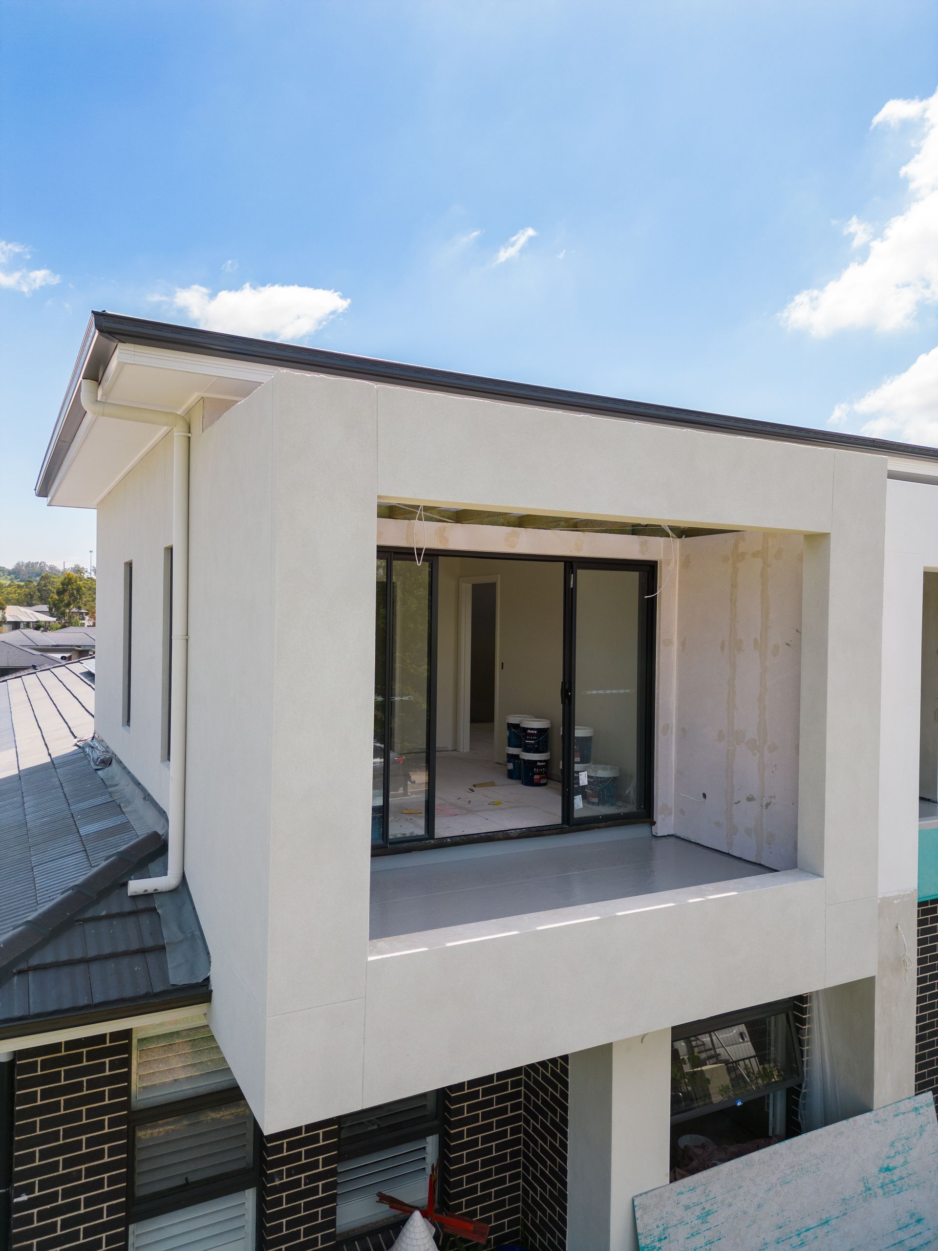 White Modern Balcony With Large Sliding Glass Doors on a Building Exterior — Matt Made Building in Camden, NSW
