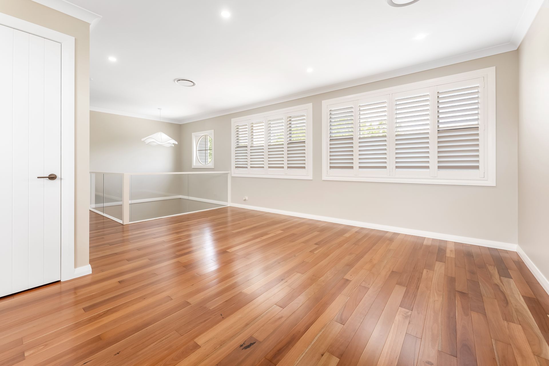 Bright Empty Room With Hardwood Floors and Large Windows — Matt Made Building in Camden, NSW