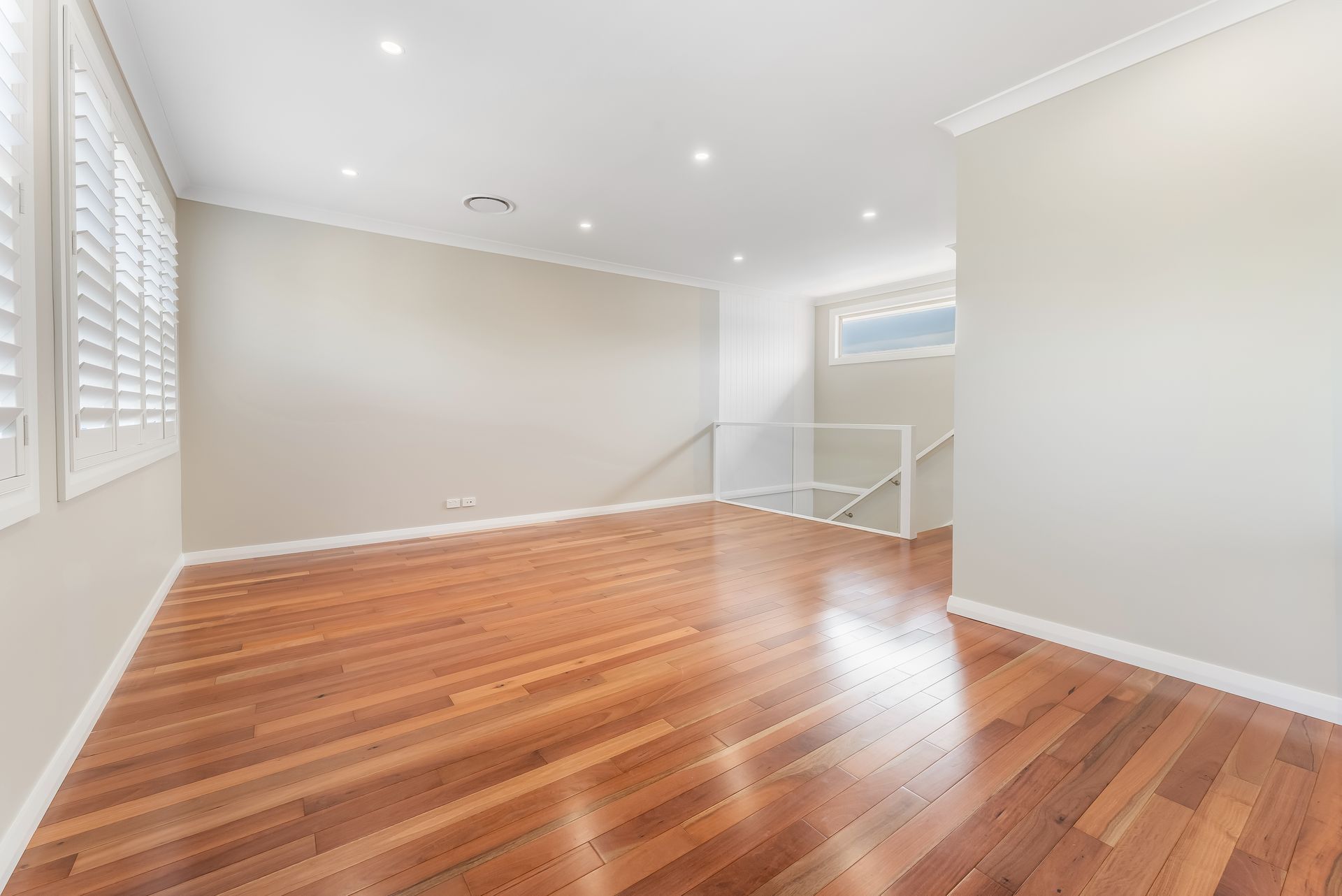 Bright Empty Room With Hardwood Floors and Recessed Ceiling Lights — Matt Made Building in Camden, NSW