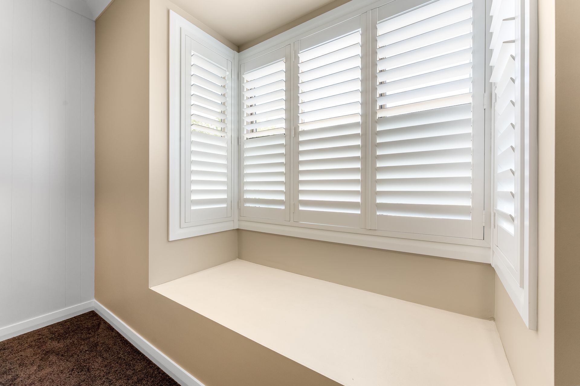 Beige Bay Window Nook With White Plantation Shutters and a Built-in Ledge — Matt Made Building in Camden, NSW