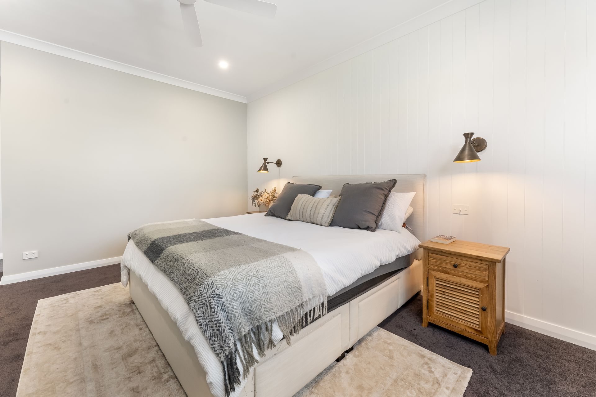 Bright Bedroom With a Neatly Made Bed and a Wooden Nightstand — Matt Made Building in Camden, NSW