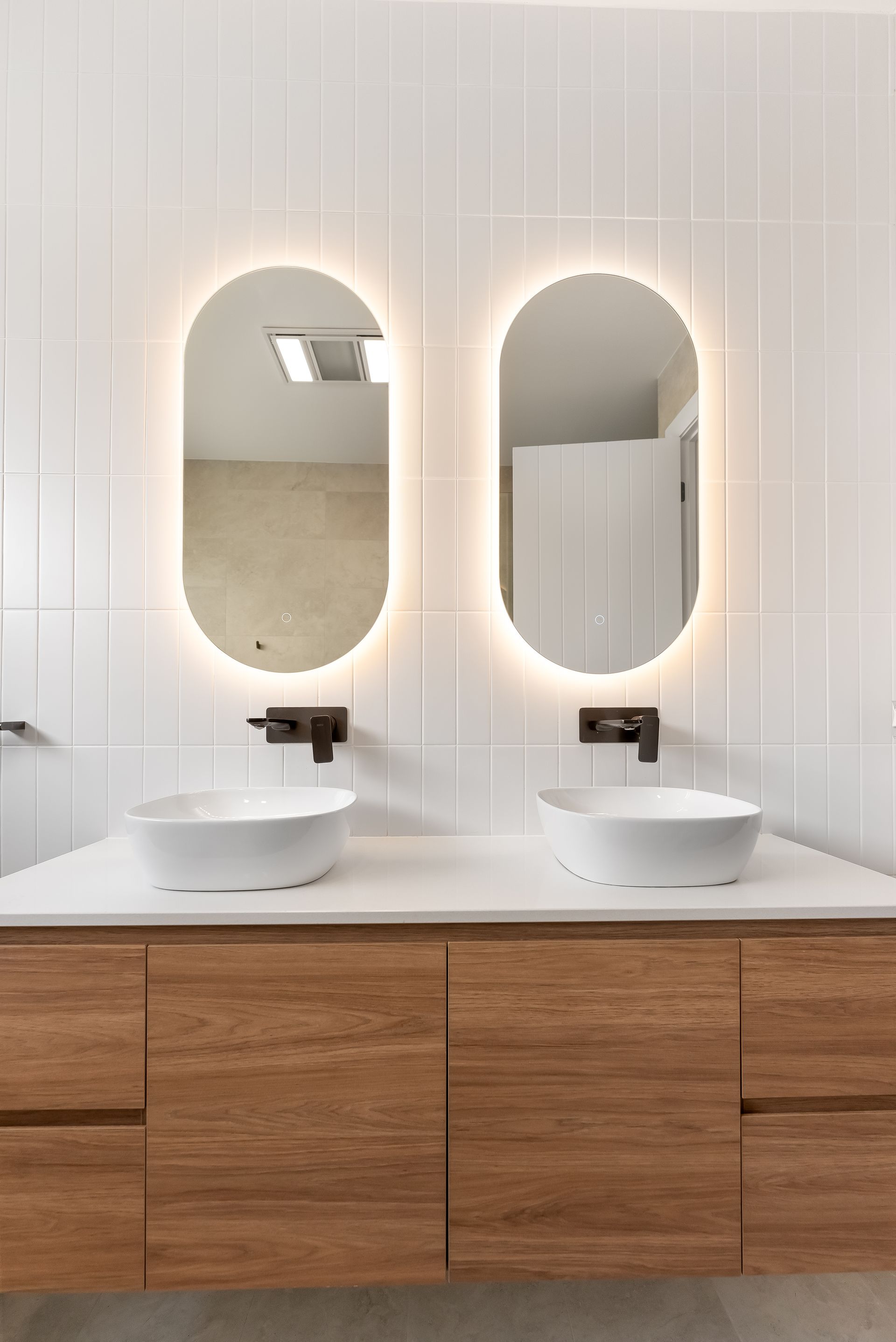 Modern Bathroom Vanity With Two Round Sinks and Wood Cabinets — Matt Made Building in Camden, NSW