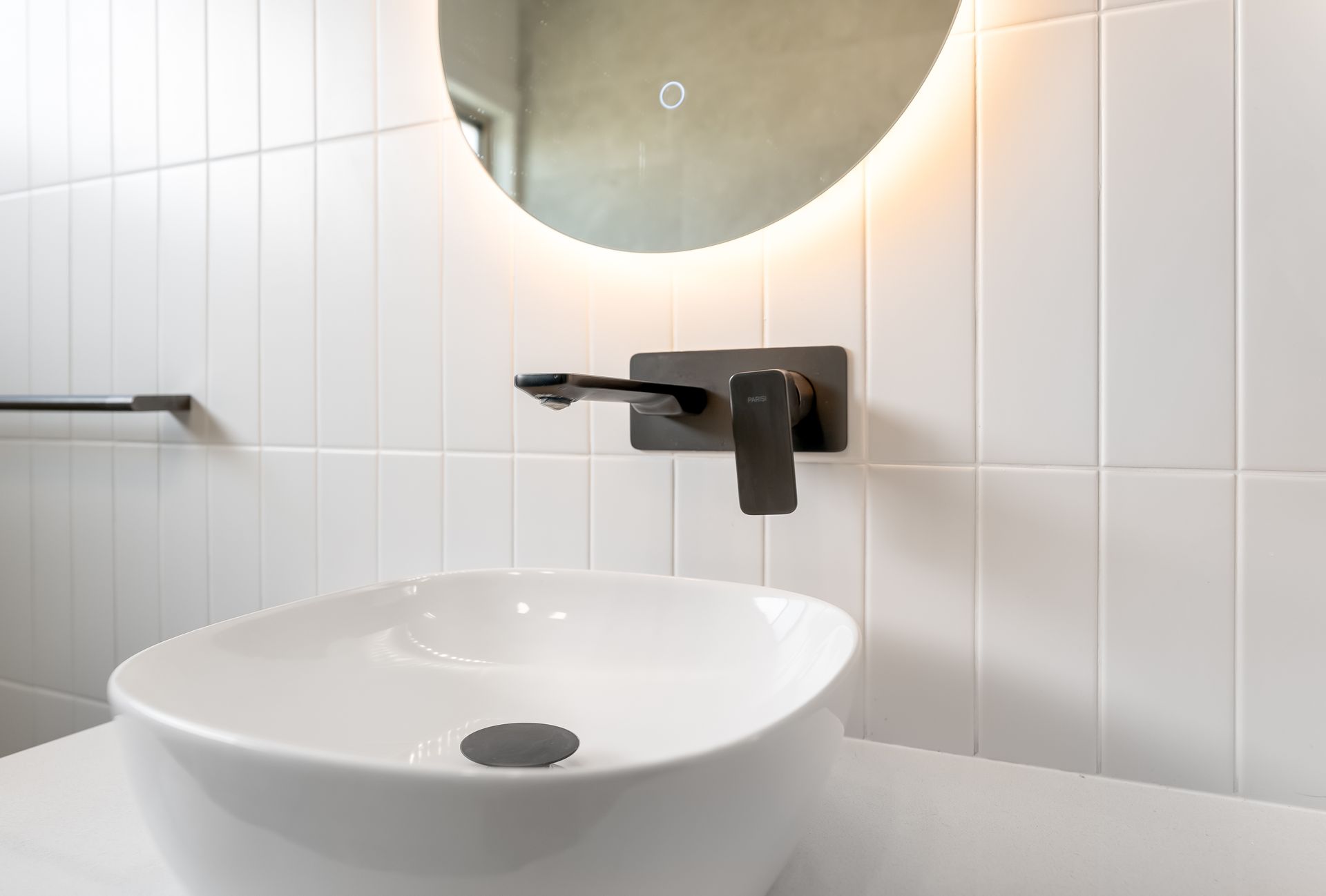 Modern Bathroom Sink With Round Mirror and Black Wall-mounted Faucet  — Matt Made Building in Camden, NSW