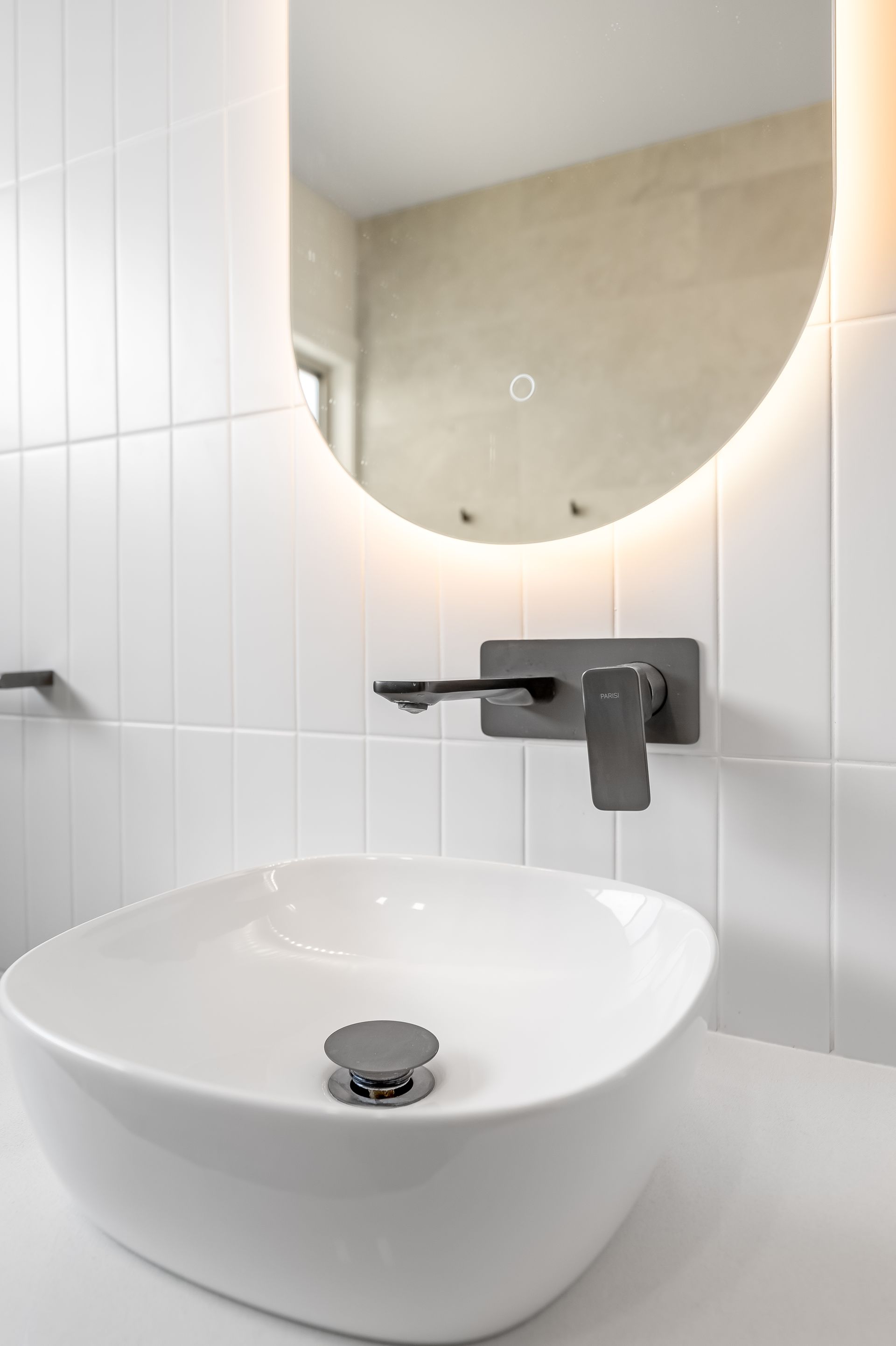 Modern White Bathroom Sink With Round Mirror and Wall-mounted Faucet — Matt Made Building in Camden, NSW