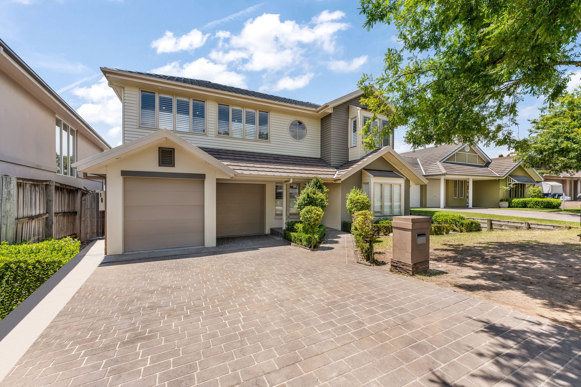 Suburban Two-story House With Garage and Trees Under a Sunny Blue Sky — Matt Made Building in Camden, NSW