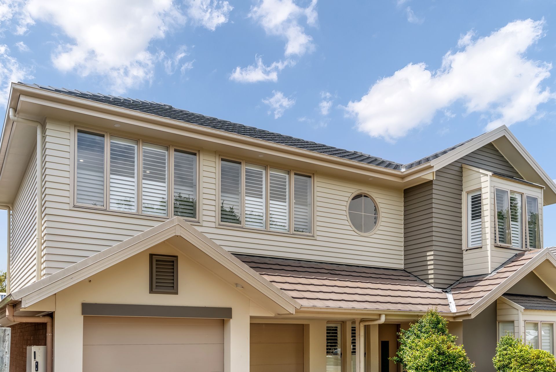 Two-story Beige Suburban House With White Trim and a Garage Under a Blue Sky — Matt Made Building in Camden, NSW