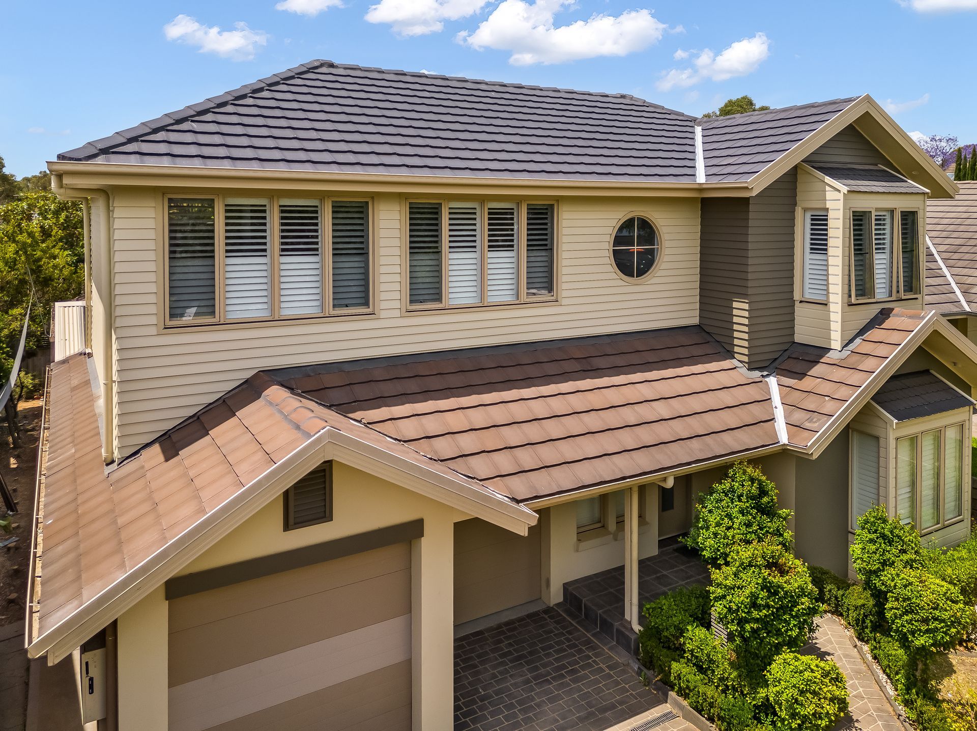 Two-story Beige House With Brown Roof and Front Porch on a Sunny Day — Matt Made Building in Camden, NSW