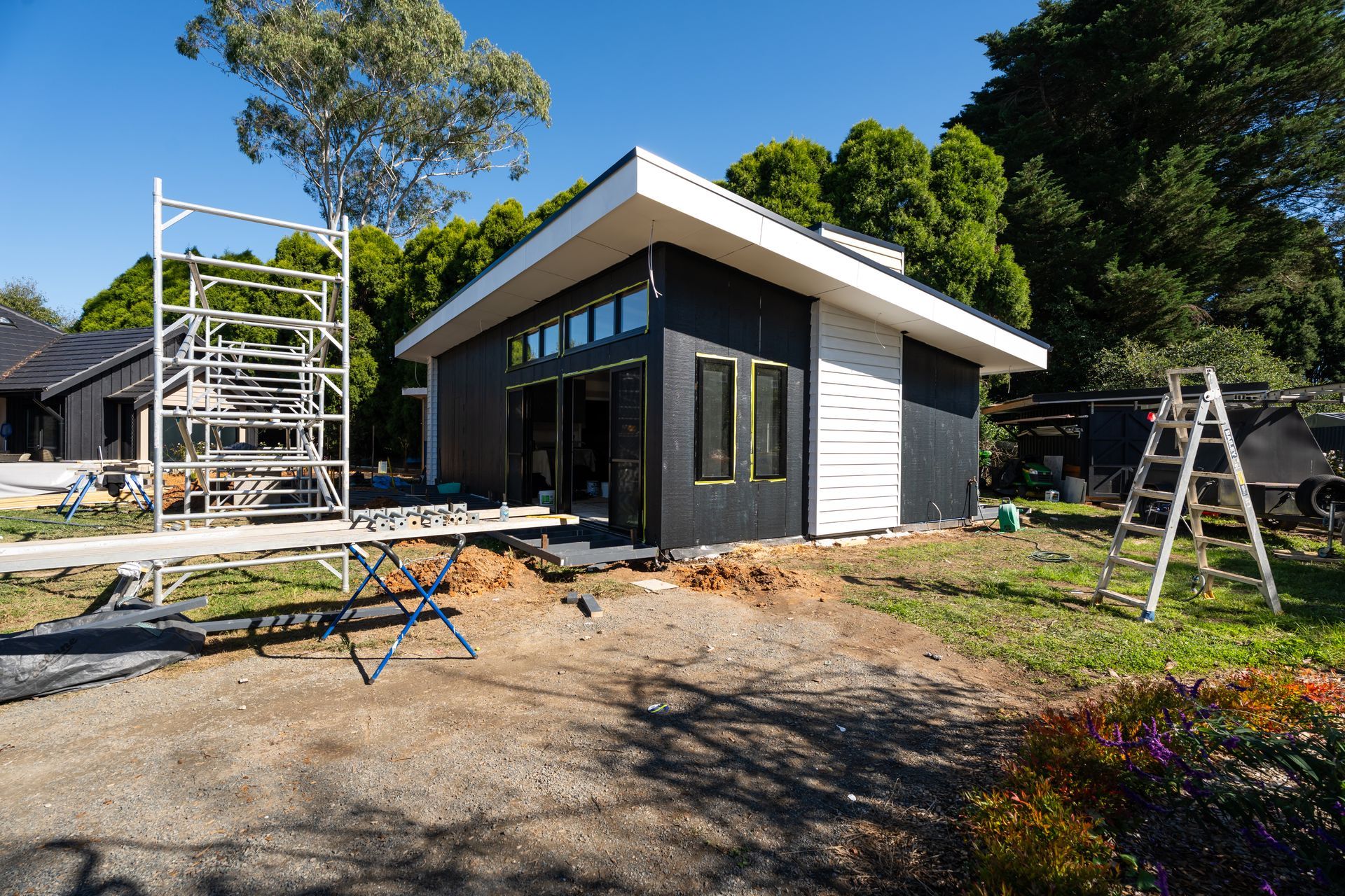 Modern House Under Construction With Scaffolding and Tools in a Sunny Yard — Matt Made Building in Camden, NSW