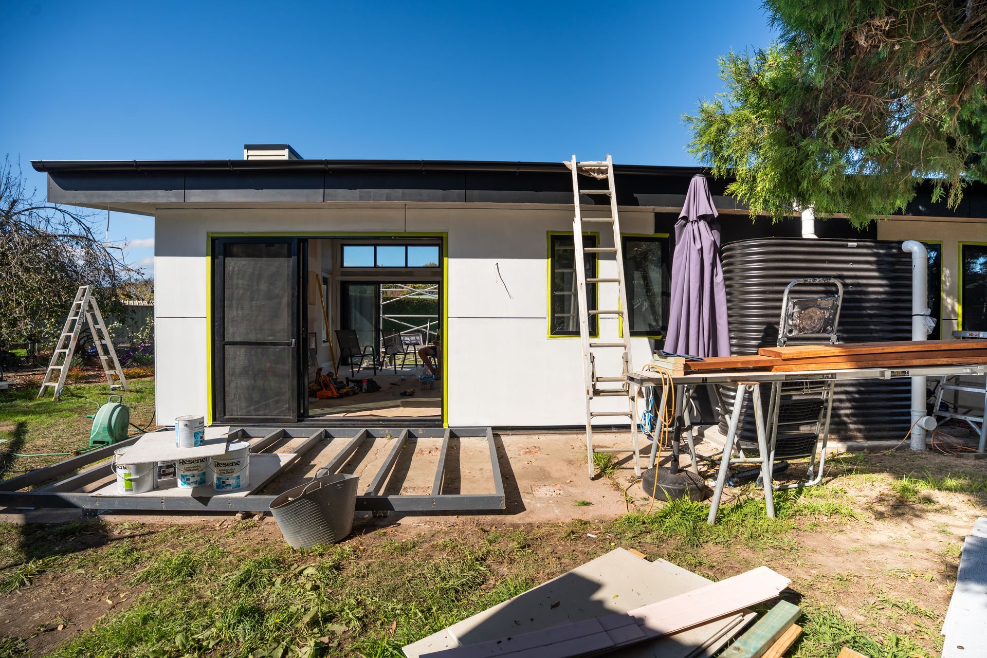Backyard Patio With Modern Shed, Lounge Chairs and Wood Planks Under Construction — Matt Made Building in Camden, NSW