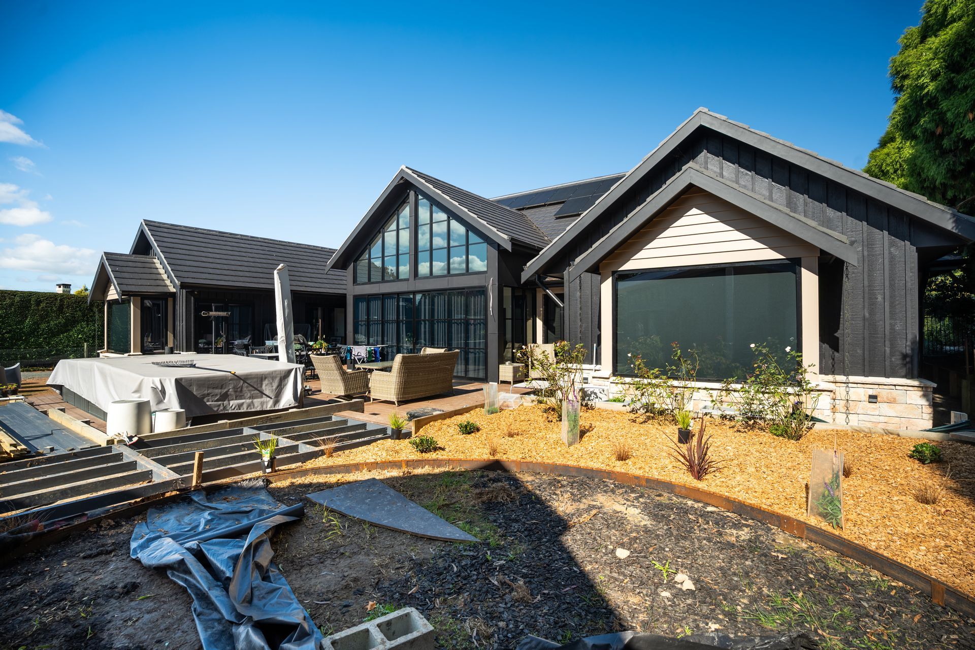 Modern Black House With Unfinished Landscaping and Construction Materials — Matt Made Building in Camden, NSW