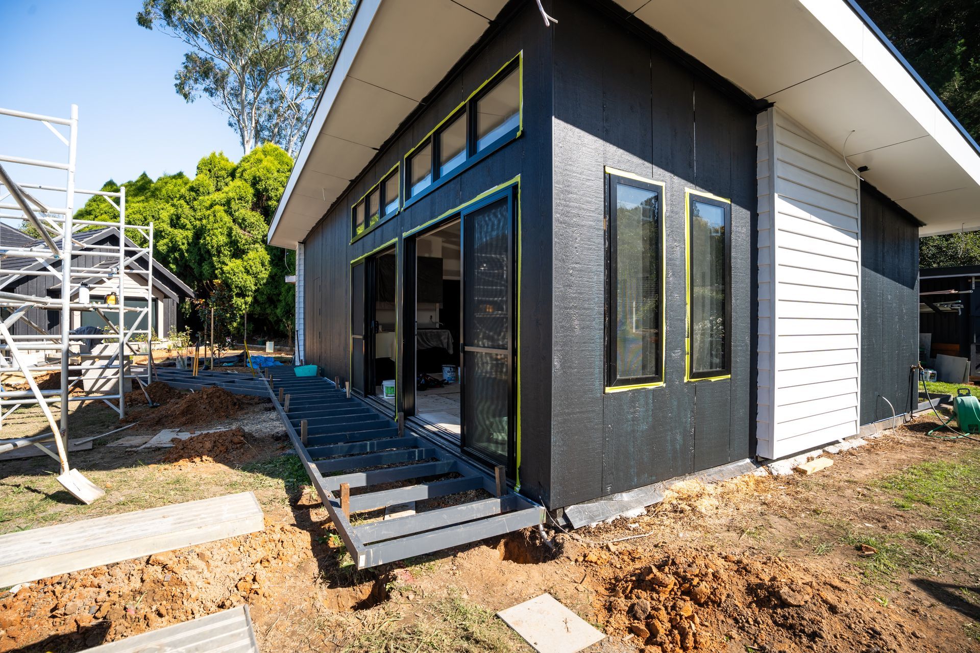 Modern Dark-gray House Exterior With Large Windows and Unfinished Landscaping — Matt Made Building in Camden, NSW