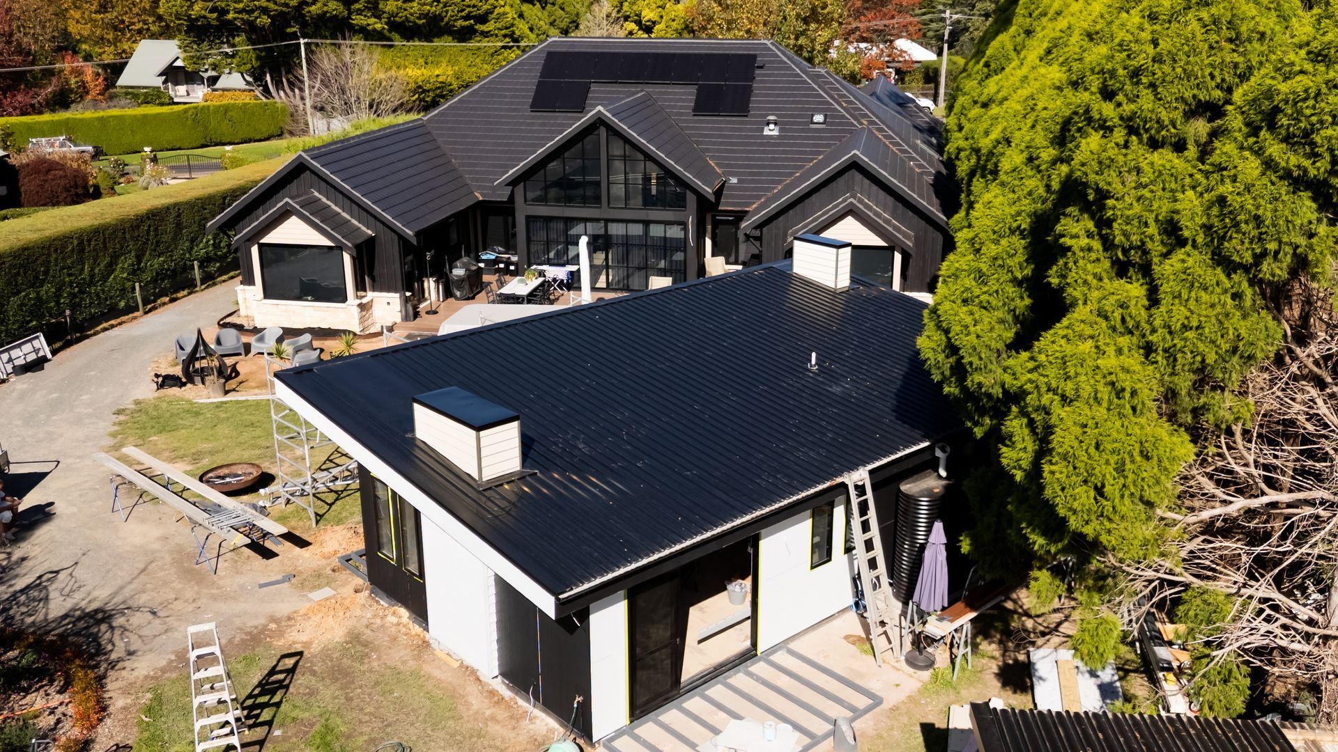Aerial View of a Modern Black-roofed House With a White Extension — Matt Made Building in Camden, NSW