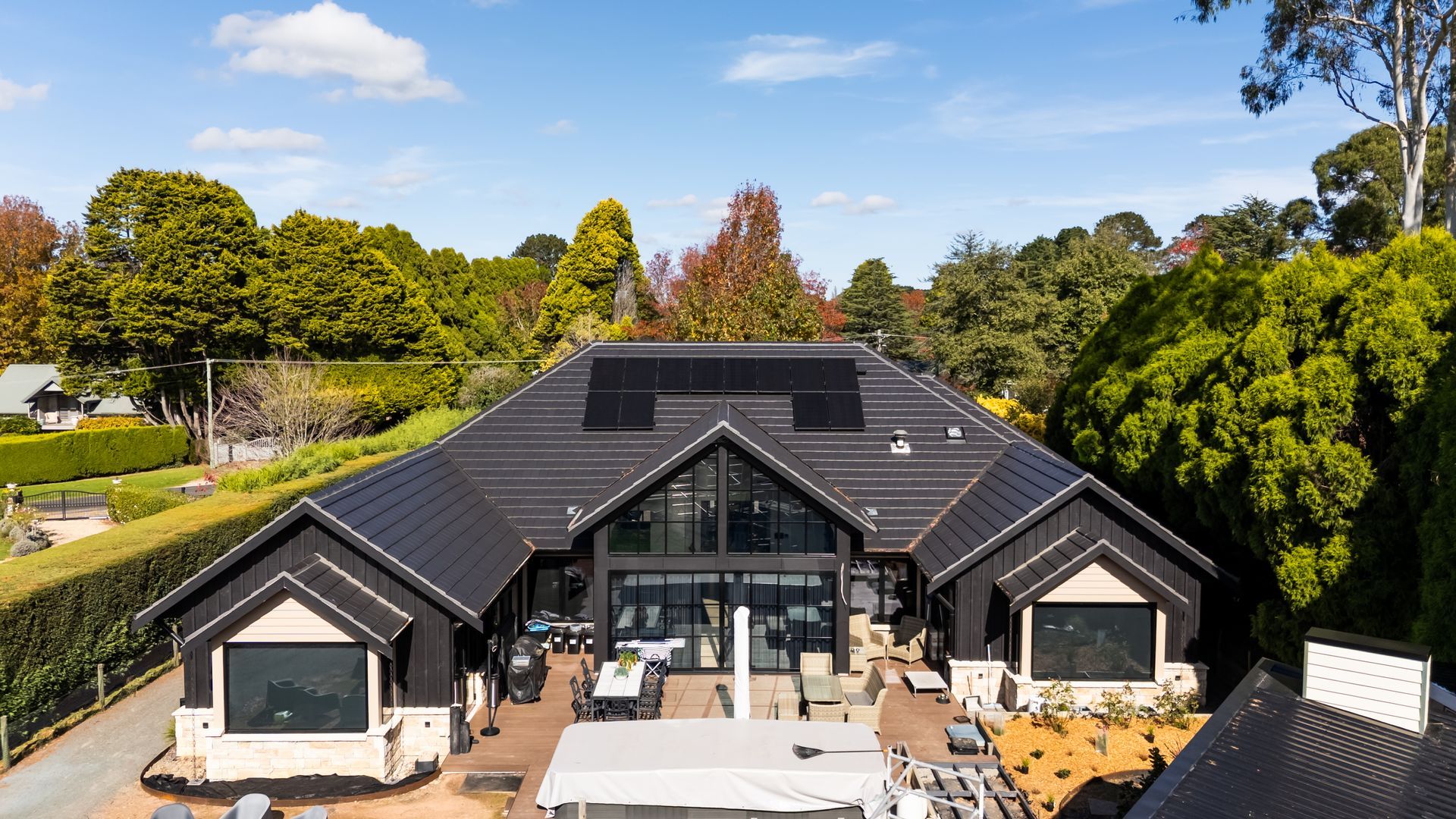 Modern Black-roofed House With Large Glass Front and Landscaped Yard — Matt Made Building in Camden, NSW