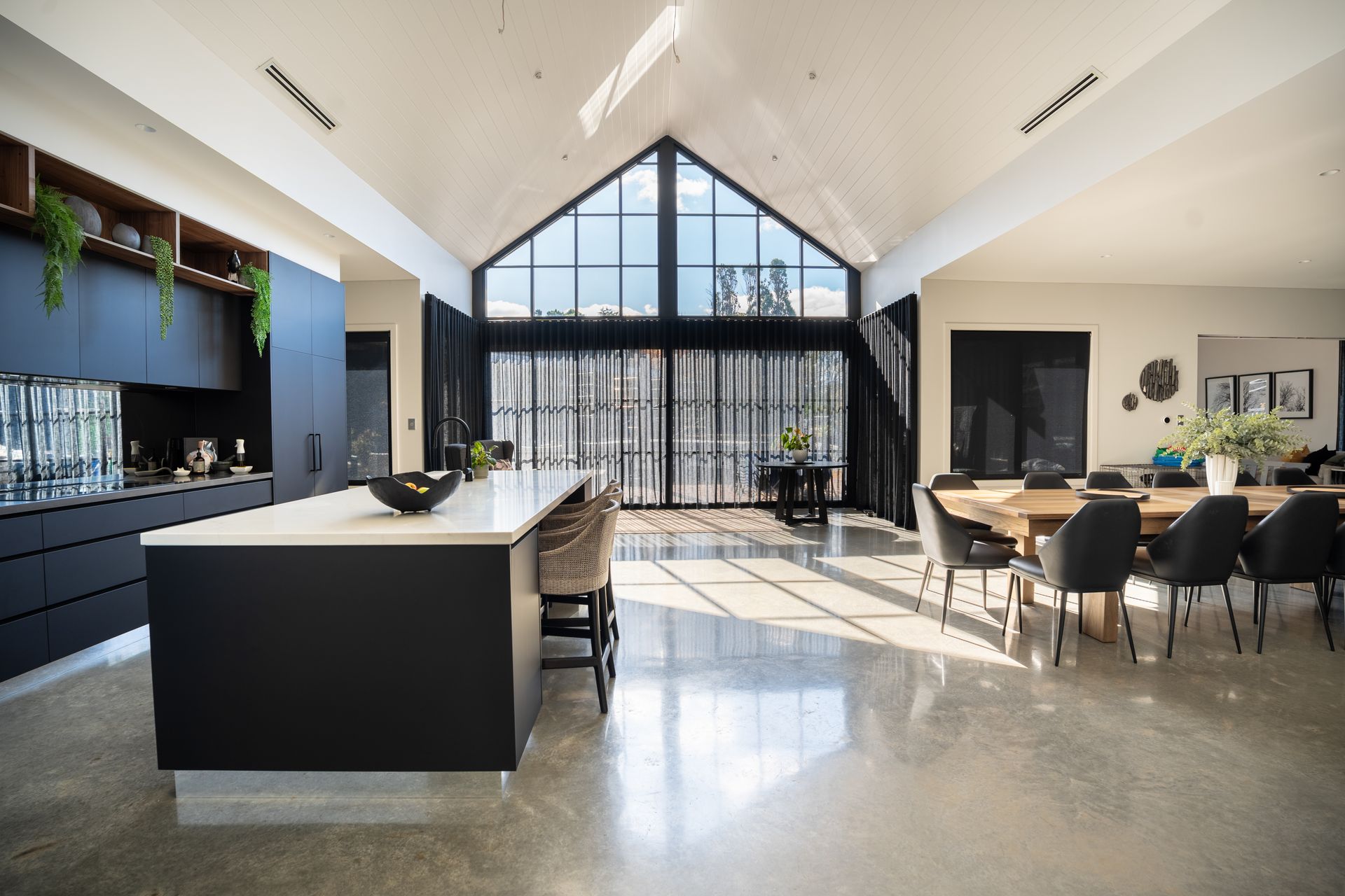Modern Open-plan Kitchen and Dining Area With Large Windows and a Central Island — Matt Made Building in Camden, NSW